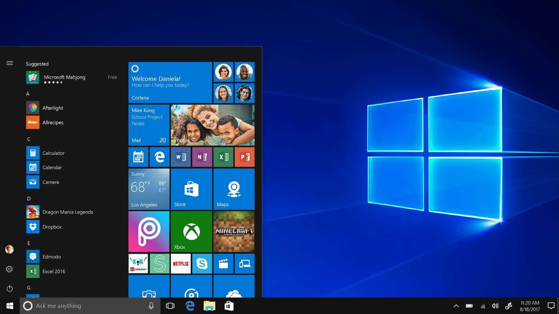 Windows Computer 桌布 壁紙 — Windows 10 開始功能表在帶有發光視窗標誌的藍色漸變桌面上打開。