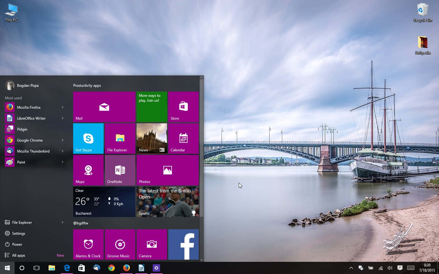 高清 桌布 壁紙 — Windows 10 開始功能表疊加在風景優美的河景上，一艘歷史悠久的船隻停泊在戲劇性的天空下。