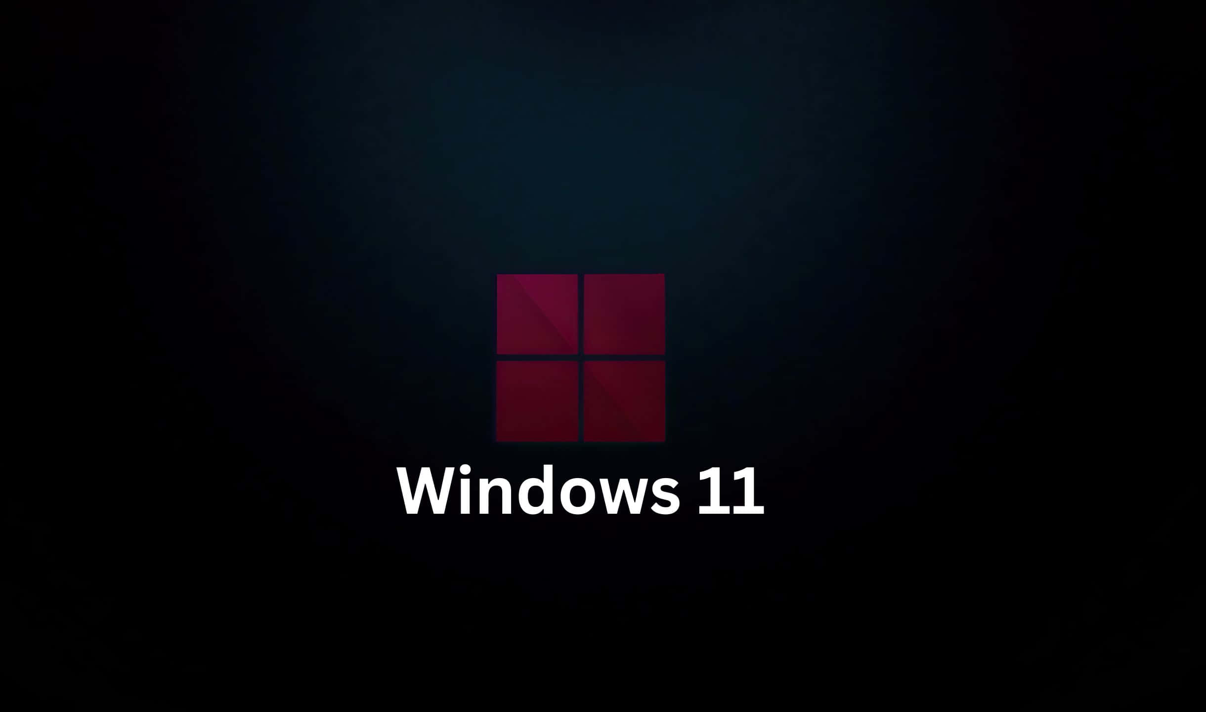 Windows 11 桌布 壁紙 — Windows 11 標誌在深色漸變背景上發出深紅色光芒，下方有白色文字。