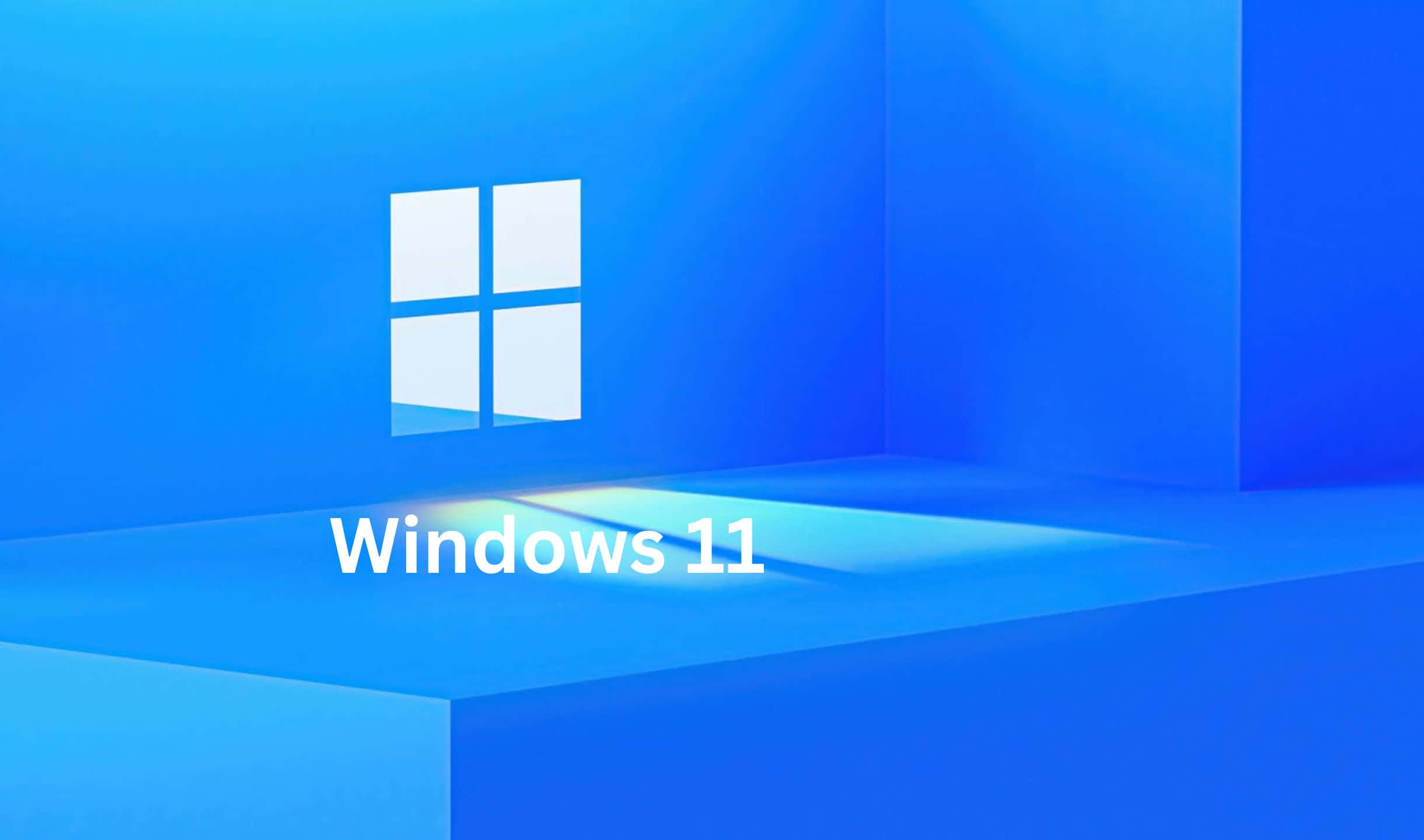 Windows 11 桌布 壁紙 — Windows 11 標誌居中於簡約藍色幾何背景上，帶有柔和燈光。