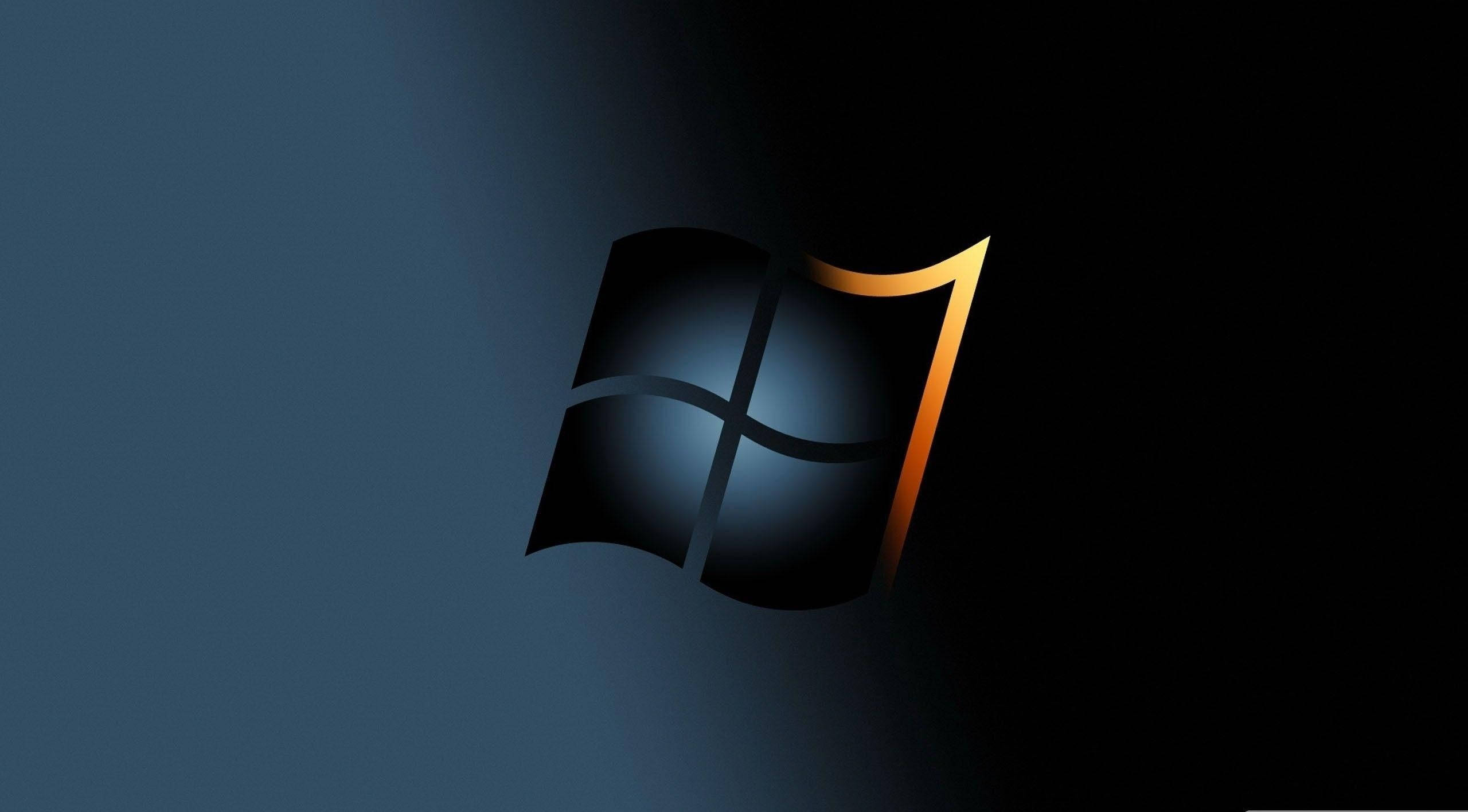 桌布 壁紙 — Windows 7 標誌在深藍色漸變背景上發出金色邊緣的光芒。