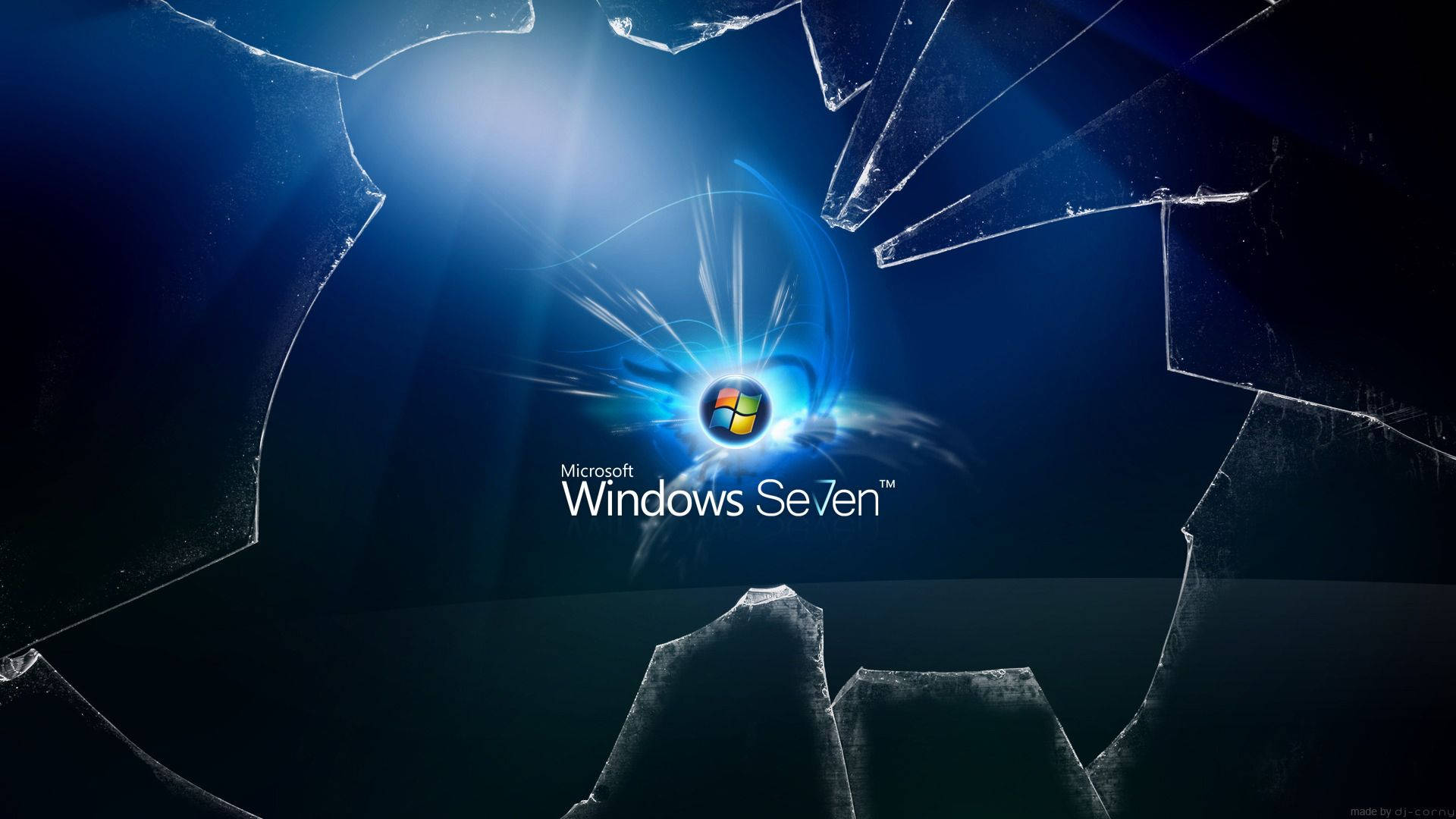 Windows 7 桌布 壁紙 — Windows Seven 標誌在深藍色背景上透過破碎的玻璃碎片閃耀光芒。