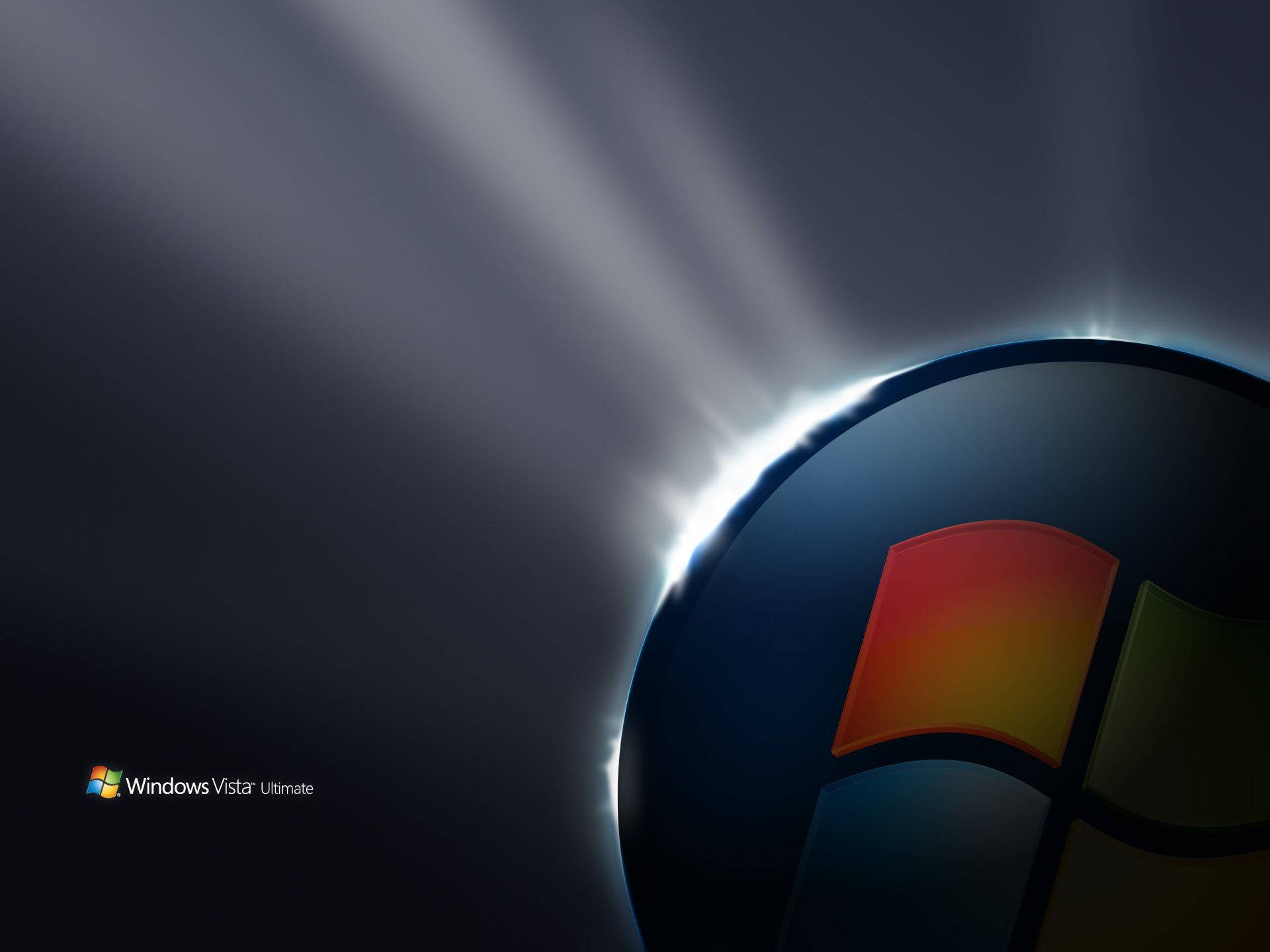 Vista 桌布 壁紙 — Windows Vista 標誌在深色漸變背景上散發出耀眼的光芒。