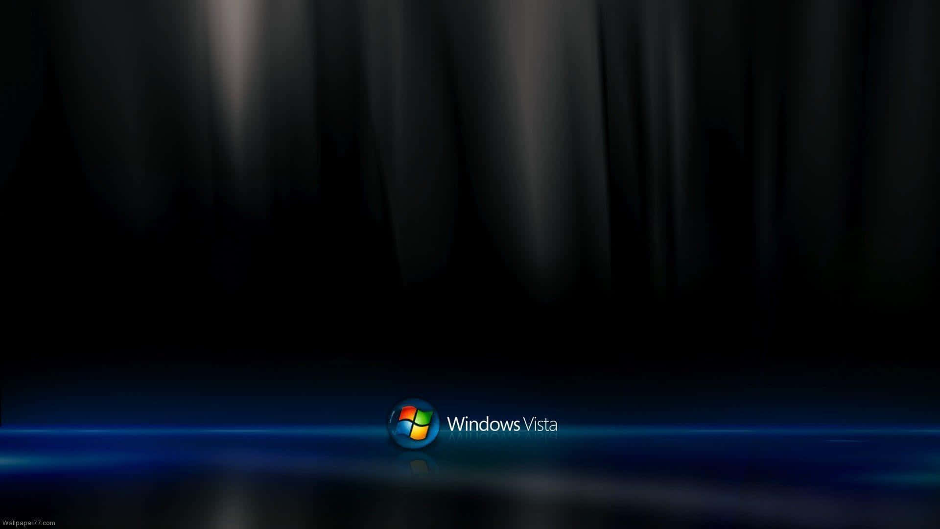 Windows Vista 標誌在黑暗舞台上以藍色燈光和窗簾背景照亮。 — Windows Vista 動態圖片 壁紙