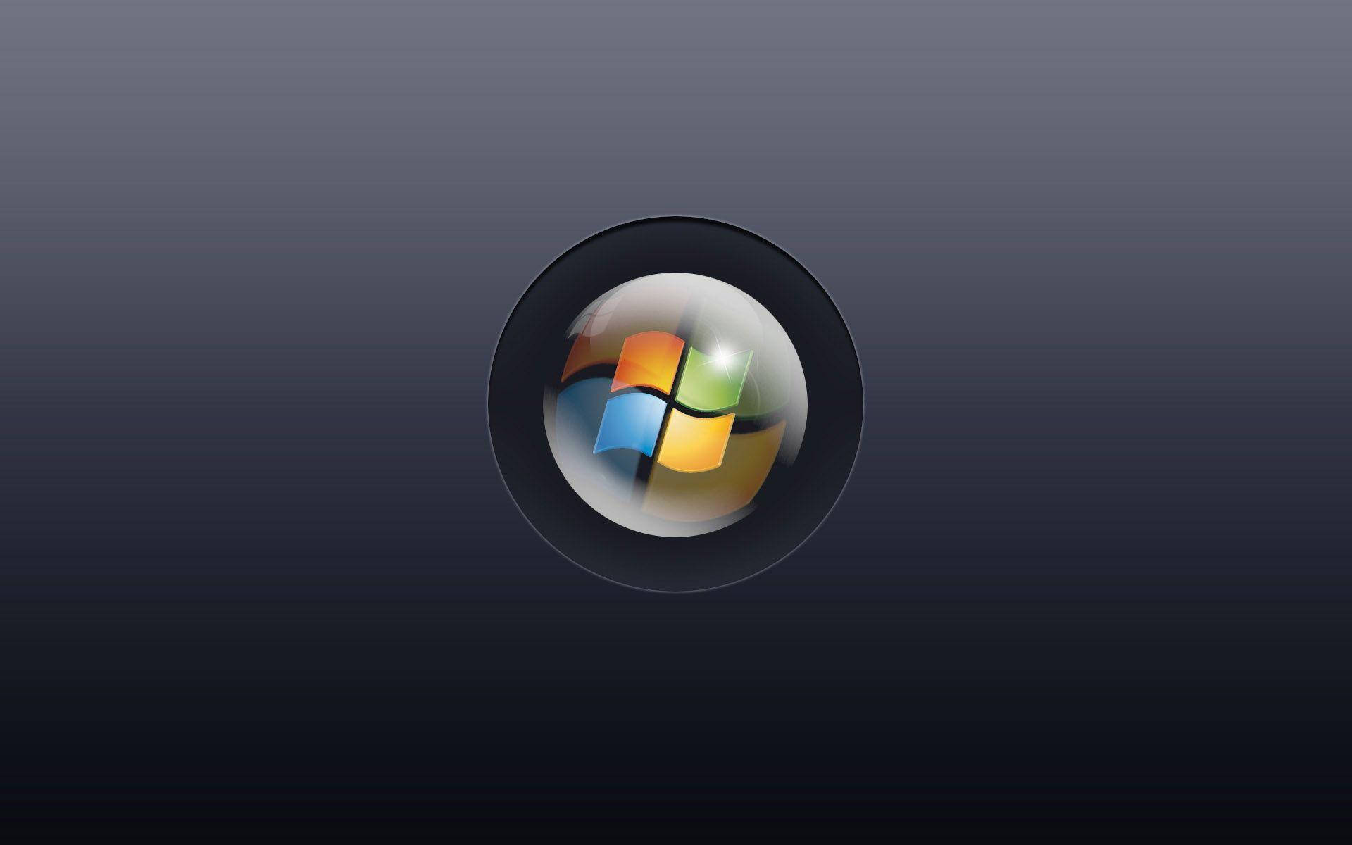 Windows 11 桌布 壁紙 — Windows 標誌圖示置中於一個有光澤的黑色圓圈內，背景為深色漸變。