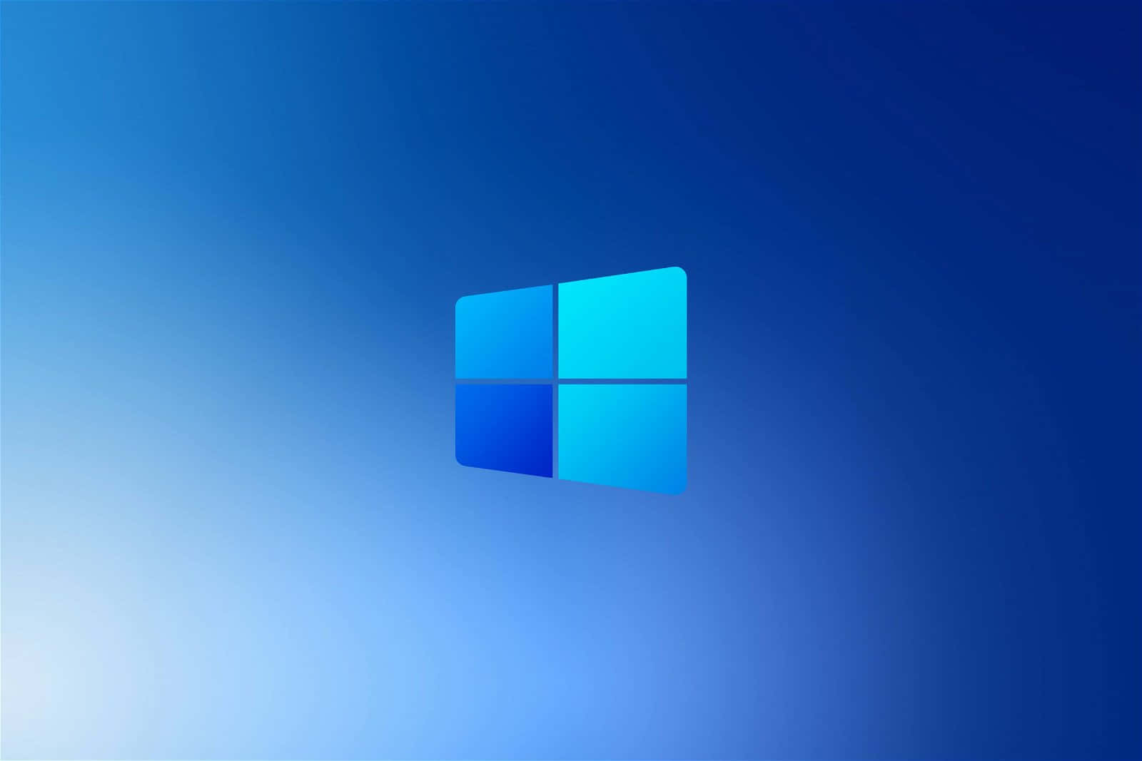 Cool Windows Desktop 桌布 壁紙 — Windows 標誌居中於漸變藍色背景上，帶有柔和燈光。