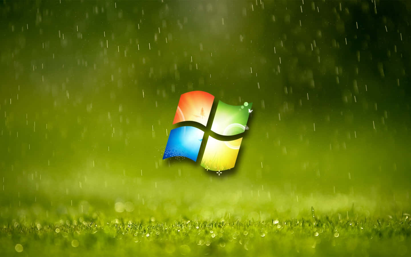 Windows Xp Logo 桌布 壁紙 — Windows 標誌漂浮在帶露水的草地上，雨水落在充滿活力的綠色背景上。