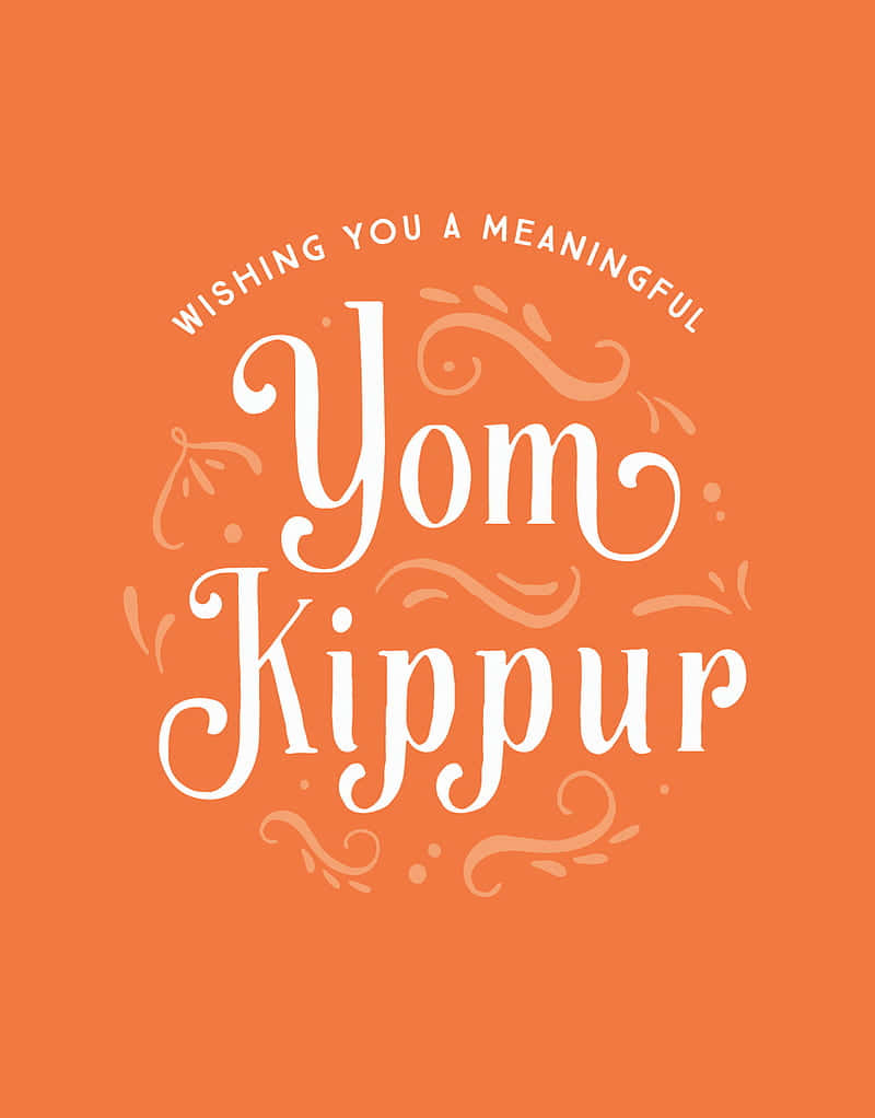  壁紙 — 溫暖的橙色背景上，優雅的白色書法寫著「Wishing You a Meaningful Yom Kippur」，並帶有裝飾性漩渦。