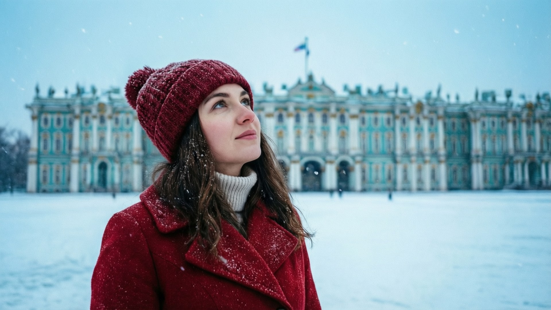 Snowy Palace View 壁紙 — 一名身穿紅色外套和針織帽的女子在飄雪中，抬頭仰望一座宏偉的雪覆蓋宮殿。