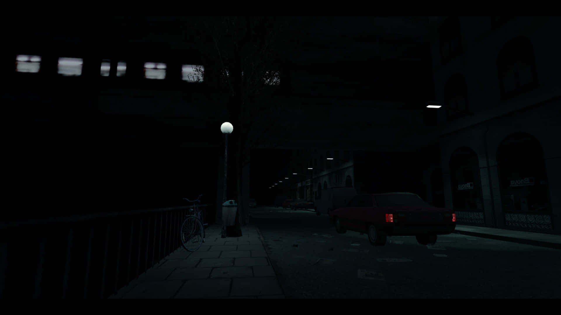  壁紙 — 夜晚一條燈光昏暗的市區街道，停著一輛紅色汽車，孤獨的路燈將微弱的光線投射在有人行道上的一輛腳踏車上。