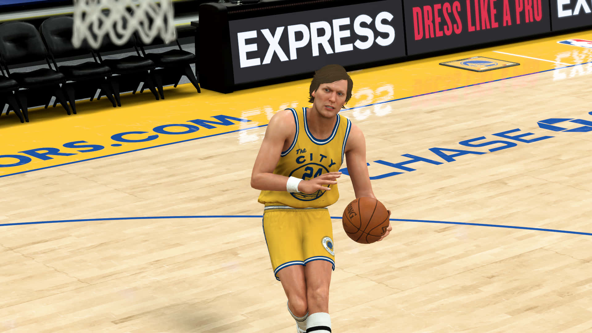 籃球運動員在球場上運球，身穿黃色球衣並帶有「The City」標誌。 — NBA 壁紙