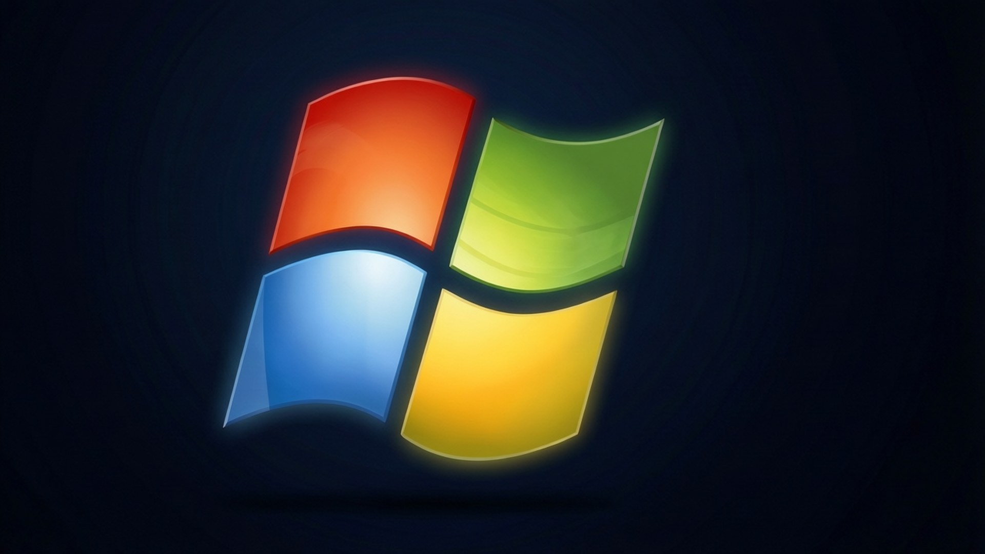 XP Logo Glow 壁紙 — 一個發光的Windows標誌，帶有紅色、綠色、藍色和黃色窗格，居中在深色漩渦背景上。