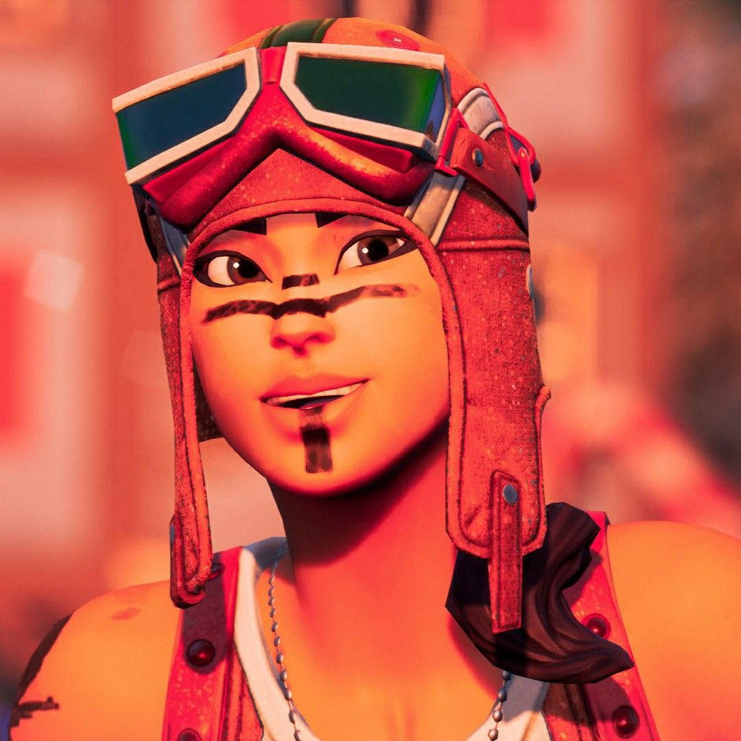 動漫角色戴著紅色護目鏡和部落臉部彩繪，溫暖地微笑。 — Fortnite 壁紙