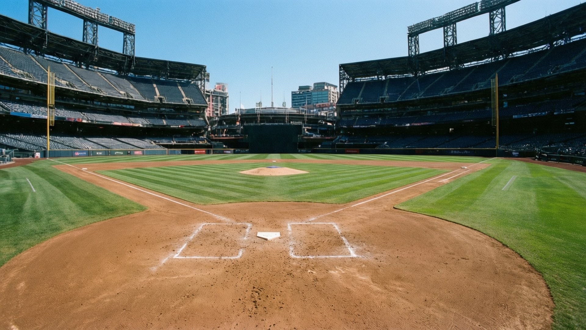 Petco Park Infield View 壁紙 — 一個空蕩蕩的棒球場的廣闊視野，擁有純淨的綠色場地和棕色泥土內野，在晴朗的藍天下。