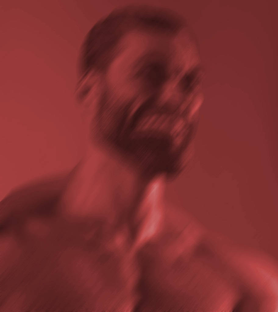 一個鬍鬚男人赤裸上身，在紅色燈光的工作室裡大笑。 — Meme 壁紙