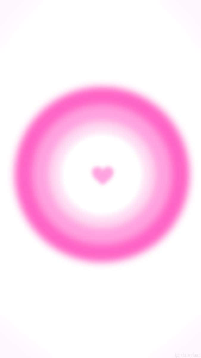 Pink Heart Aura 桌布 壁紙 — 一個柔和的粉紅色心形，位於發光的同心圓環中央，背景為純白色。