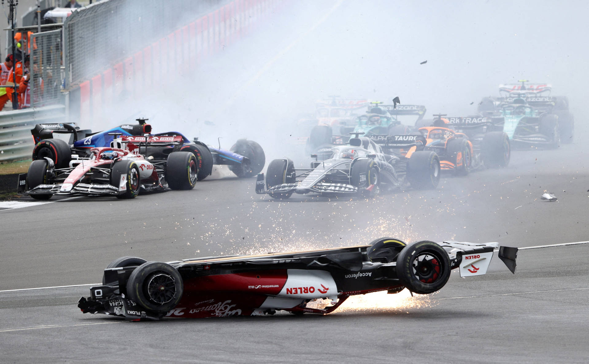 一級方程式賽車在賽道上相撞，冒出濃煙和火花。 — F1 壁紙