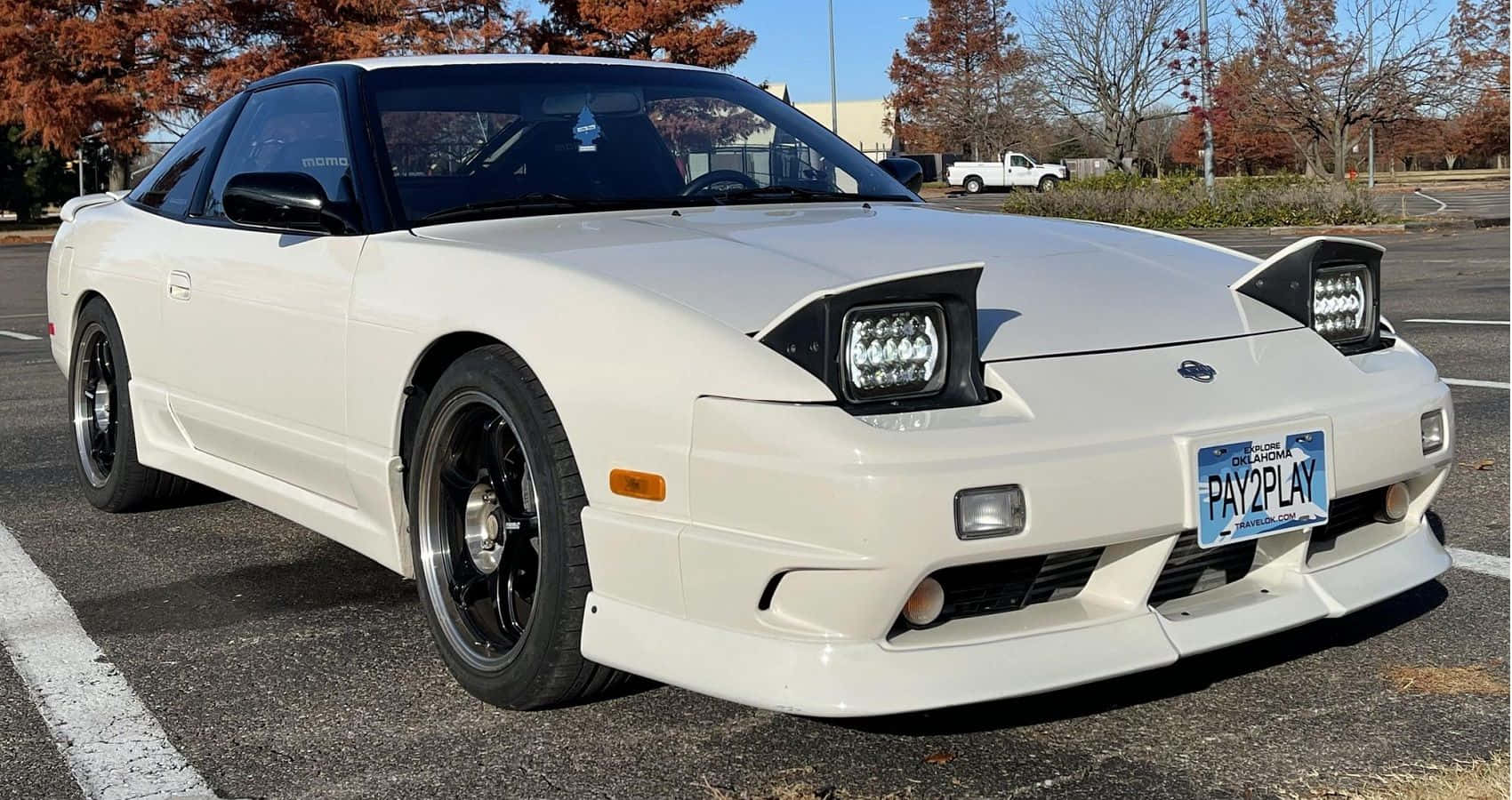 壁紙 — 一輛純白色的日產300ZX跑車停放在停車場，周圍有秋天的樹木和晴朗的藍天。