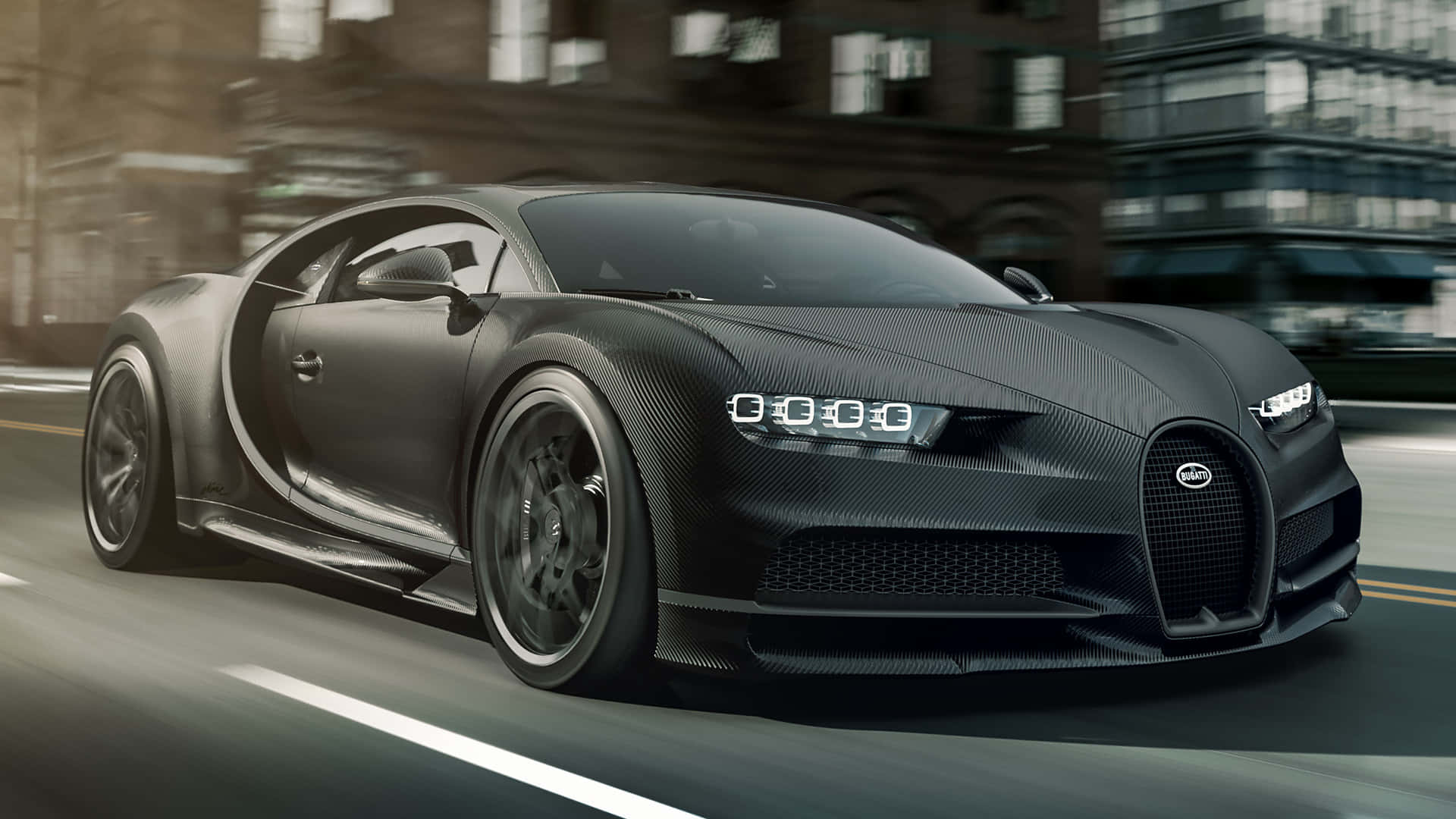 Bugatti Chiron 桌布 壁紙 — 一輛霧面黑色的Bugatti Chiron在模糊的城市街道上飛馳，動態模糊凸顯其流線型碳纖維設計。