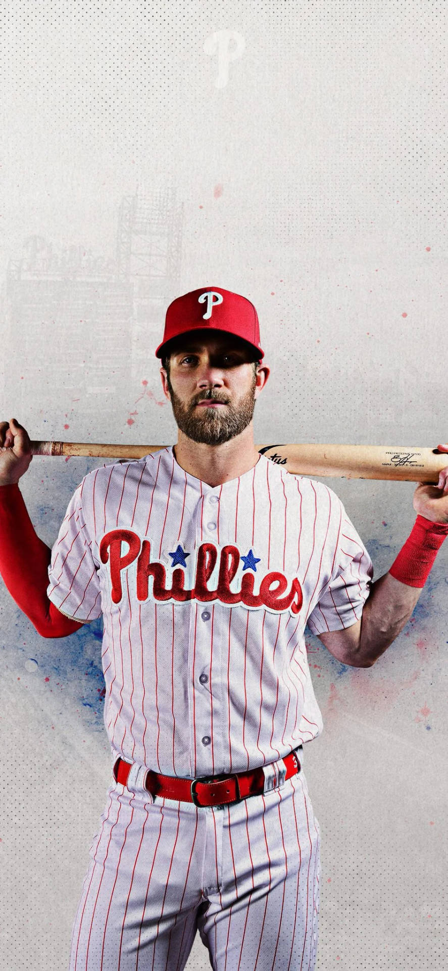 身穿費城人隊球衣的棒球選手，在紋理灰色背景前手持球棒。 — MLB 壁紙
