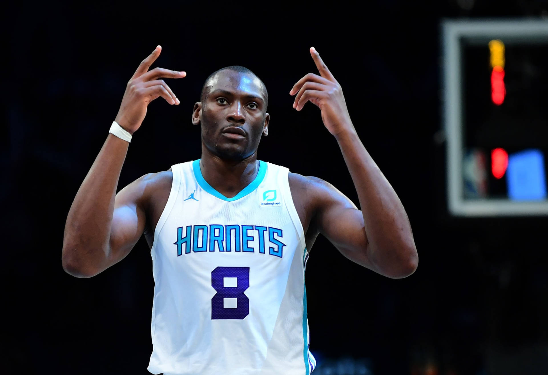 身穿黃蜂隊球衣的籃球運動員在比賽中做手勢。 — Jordan Logo 壁紙