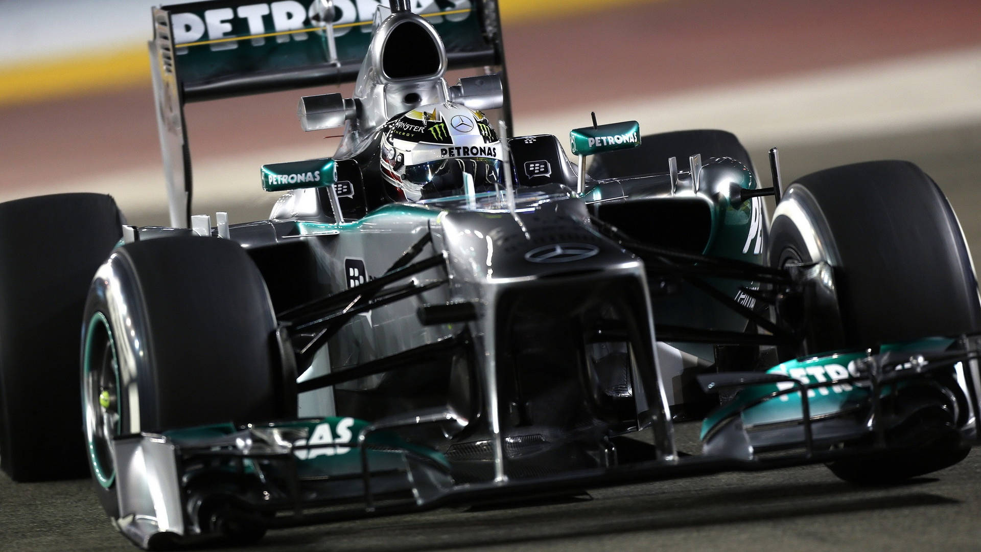 賓士一級方程式賽車在夜間賽道上疾馳，燈光閃爍。 — F1 壁紙