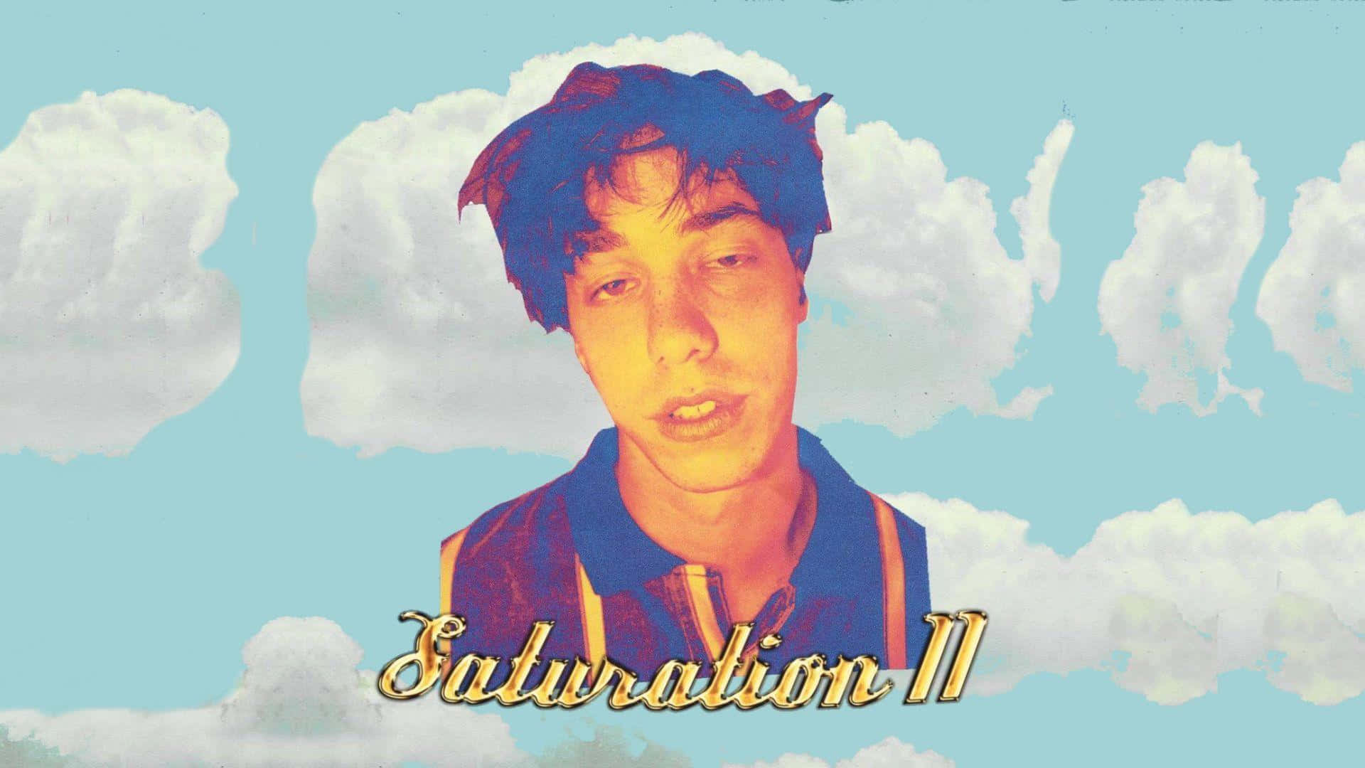 Brockhampton 桌布 壁紙 — 一位頭髮蓬鬆的年輕男子在風格化的雲朵中漂浮，背景是粉藍色天空，下方有金色文字。