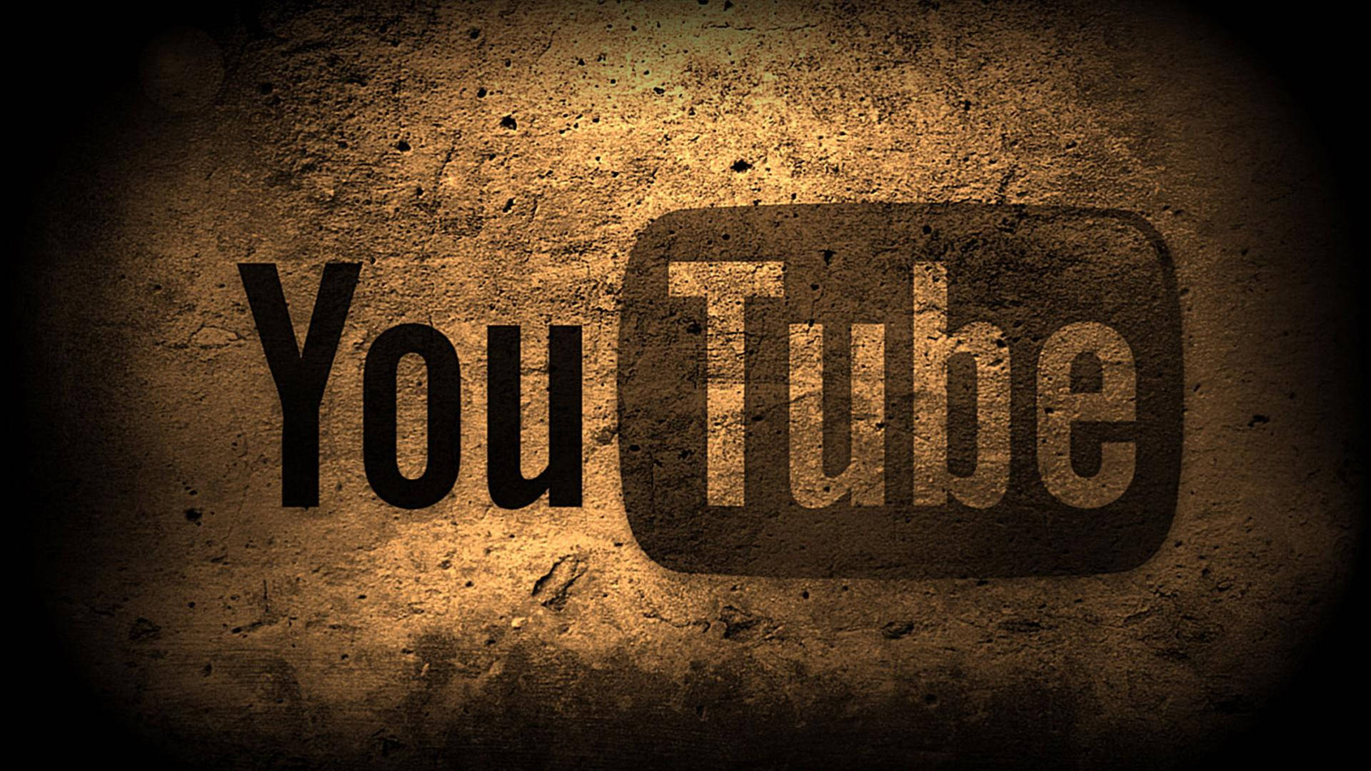 美學 桌布 壁紙 — YouTube 標誌蝕刻在粗糙紋理牆壁上，帶有溫暖聚光燈效果和暗色暈影。