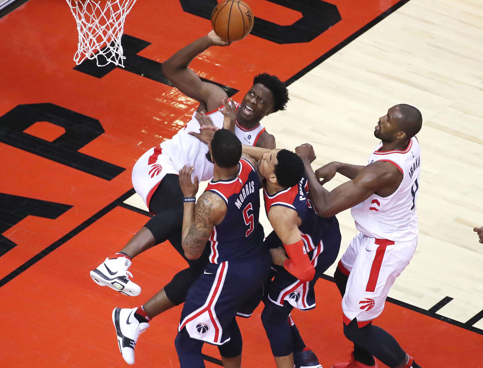 籃球運動員在籃框附近爭奪投籃機會。 — NBA 壁紙