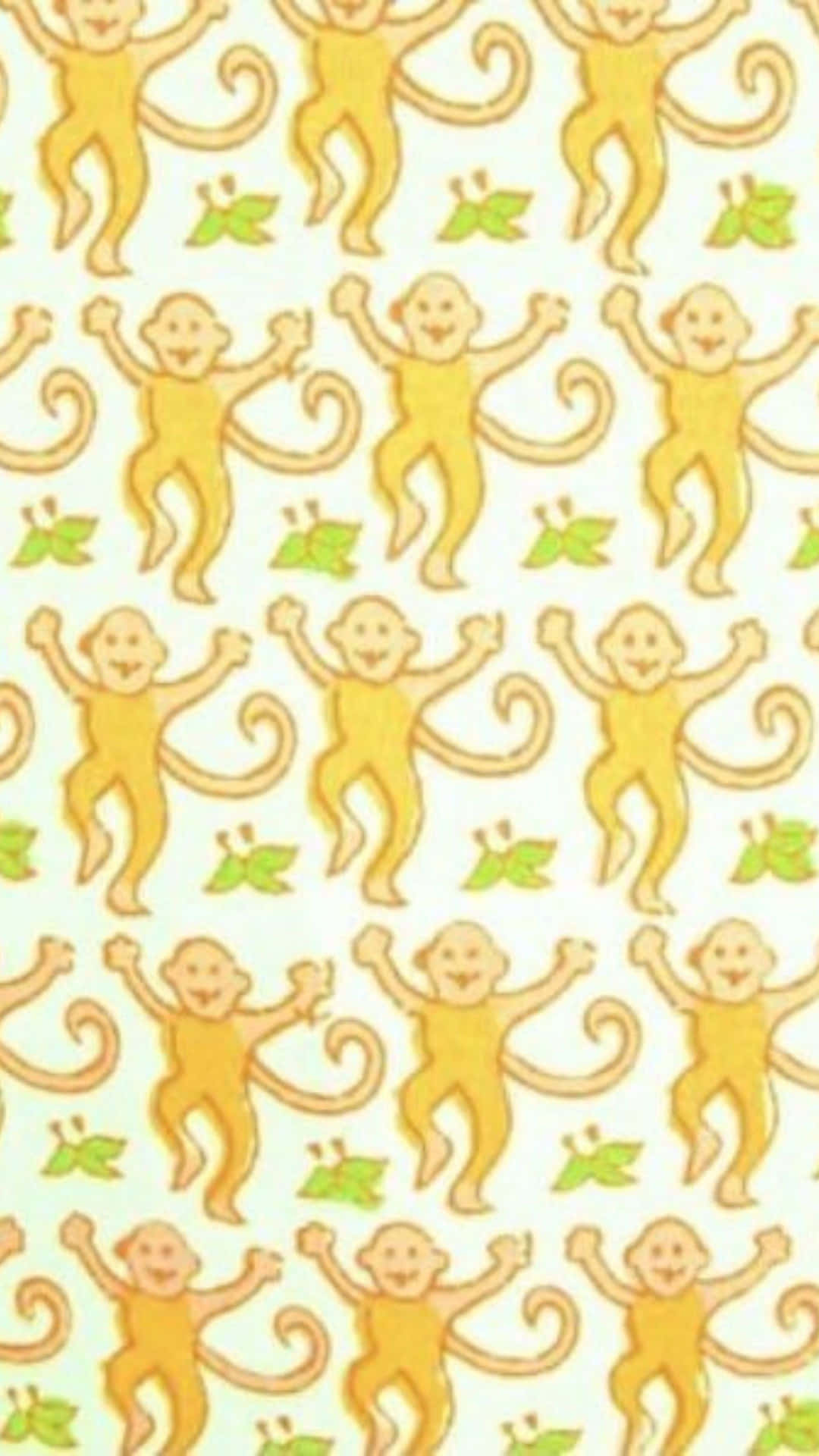  壁紙 — 在淺奶油色背景上重複出現的快樂黃色卡通猴子圖案，搭配綠色葉子。