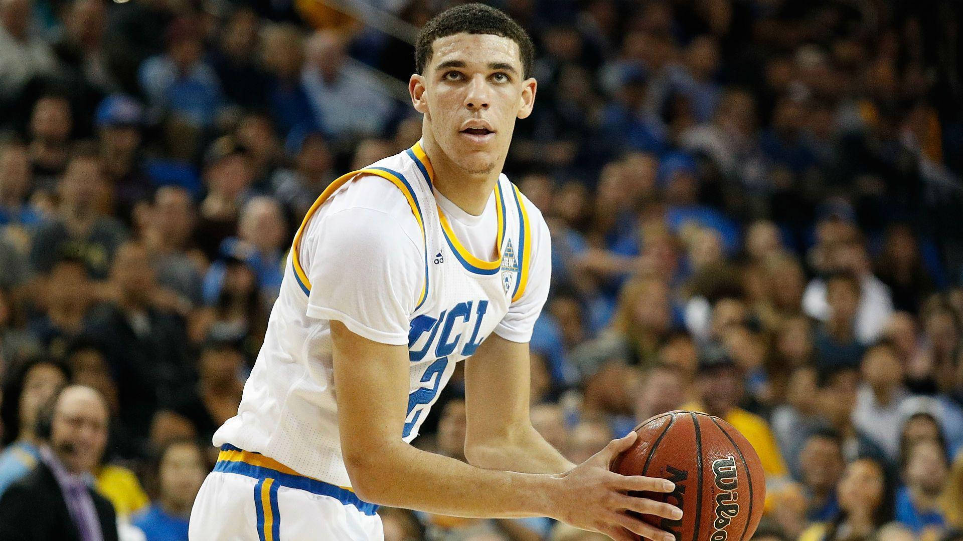 UCLA籃球運動員在比賽中運球，背景有觀眾。 — NBA 壁紙