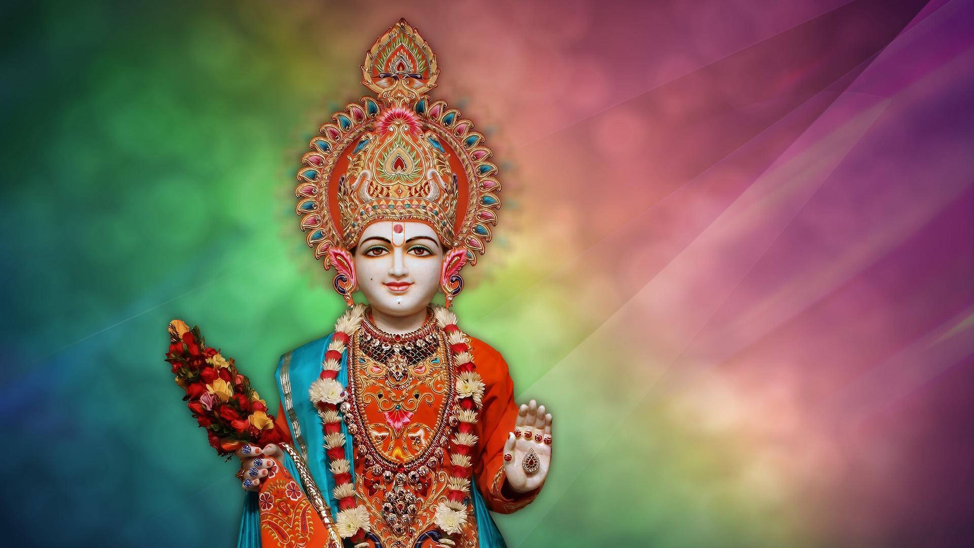 Swaminarayan 桌布 壁紙 — 一位光彩照人的印度教女神，佩戴著精緻的珠寶和色彩繽紛的皇冠，站在充滿活力的漸變背景前。