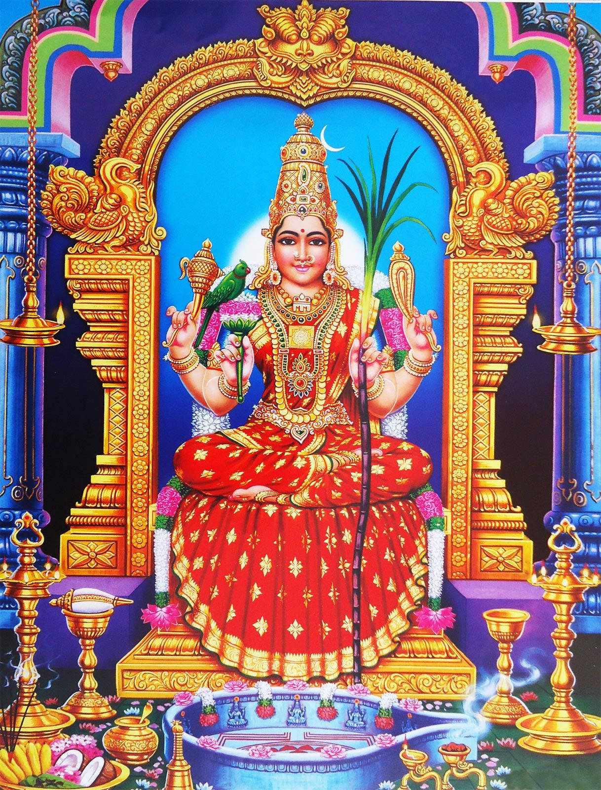 Hindu Temple 桌布 壁紙 — 一位光彩照人的印度教女神，身著紅金相間的服飾，威嚴地坐在寶座上，周圍環繞著華麗的裝飾和供品。