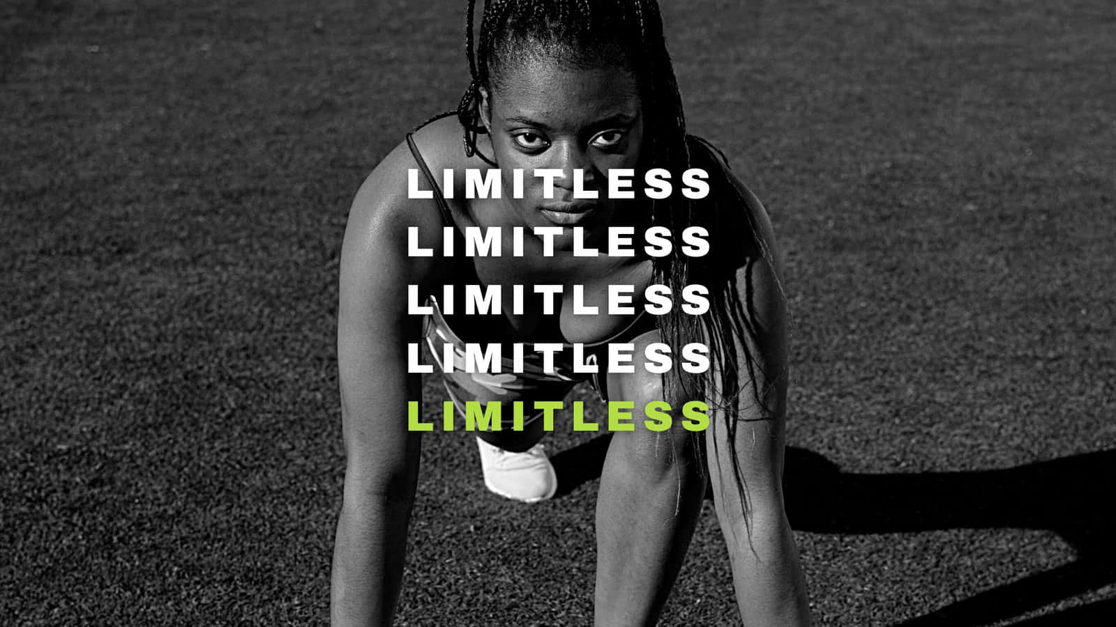 Word 桌布 壁紙 — 一位堅定的女性穿著運動裝備蹲在瀝青上，單詞 limitless 以粗體白色和綠色文字重複出現。