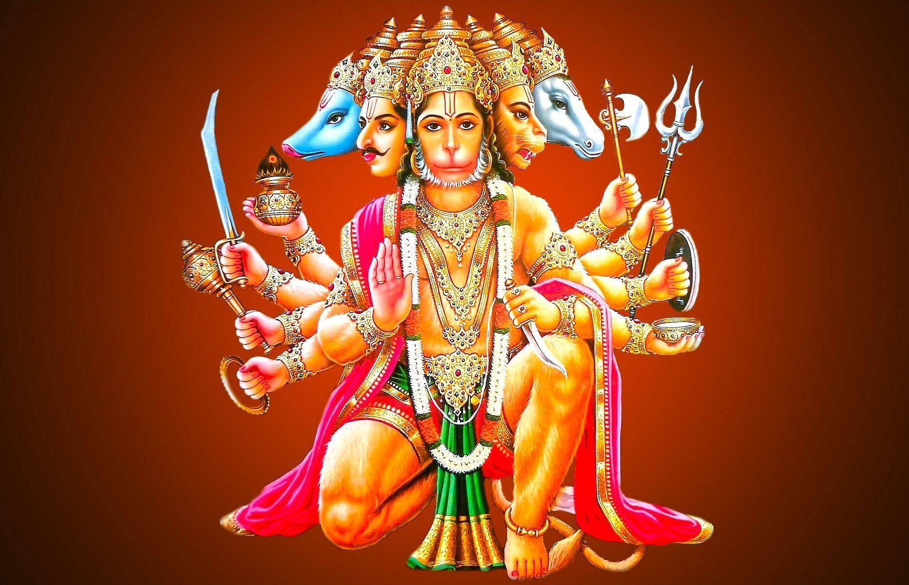Anjaneya 桌布 壁紙 — 一位多臂印度教神祇，擁有藍白相間的馬頭，飾有黃金首飾和紅綠服飾，在溫暖的棕色背景前手持武器。