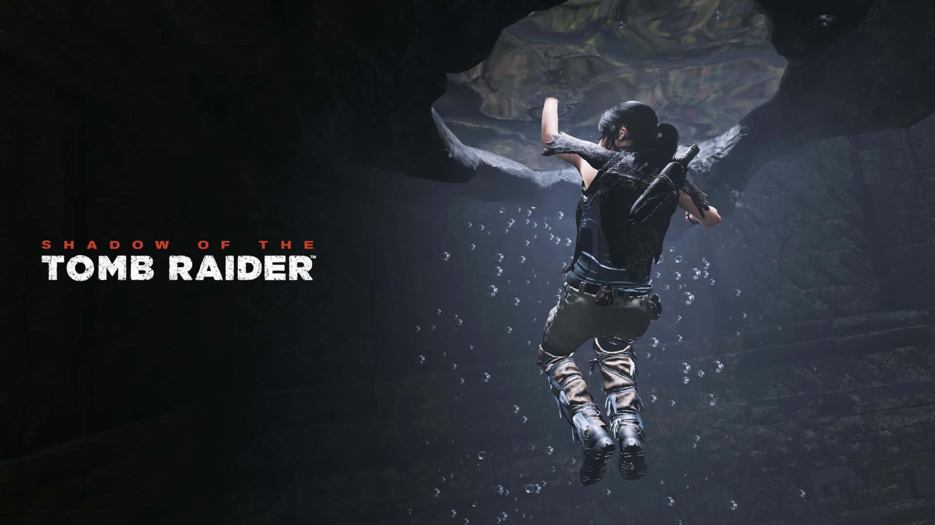 Lara Croft 桌布 壁紙 — 一位女性冒險家潛過黑暗的水底洞穴，氣泡在她周圍升起。