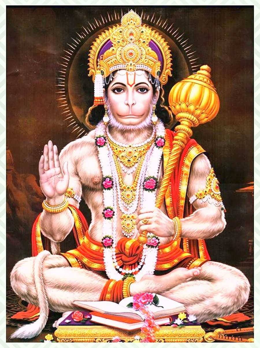 lord hanuman HD 桌布 壁紙 — 一位威嚴的金冠猴神盤腿而坐，飾有珠寶和鮮花，手持狼牙棒並做出祝福手勢。