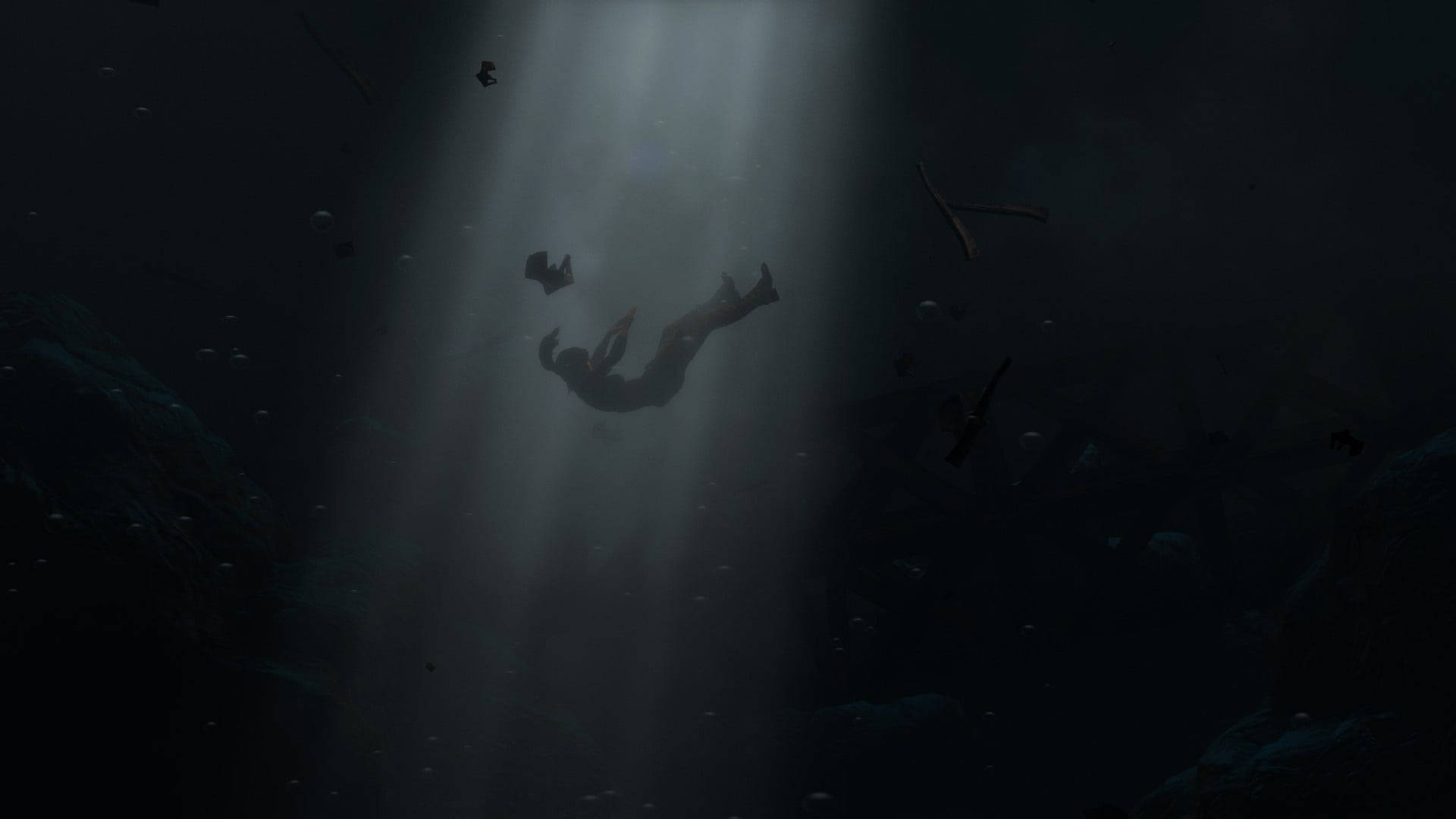 Rise Of The Tomb Raider 桌布 壁紙 — 一位孤獨的潛水員漂浮在深海黑暗中，被一道穿過水面的陽光照射著。