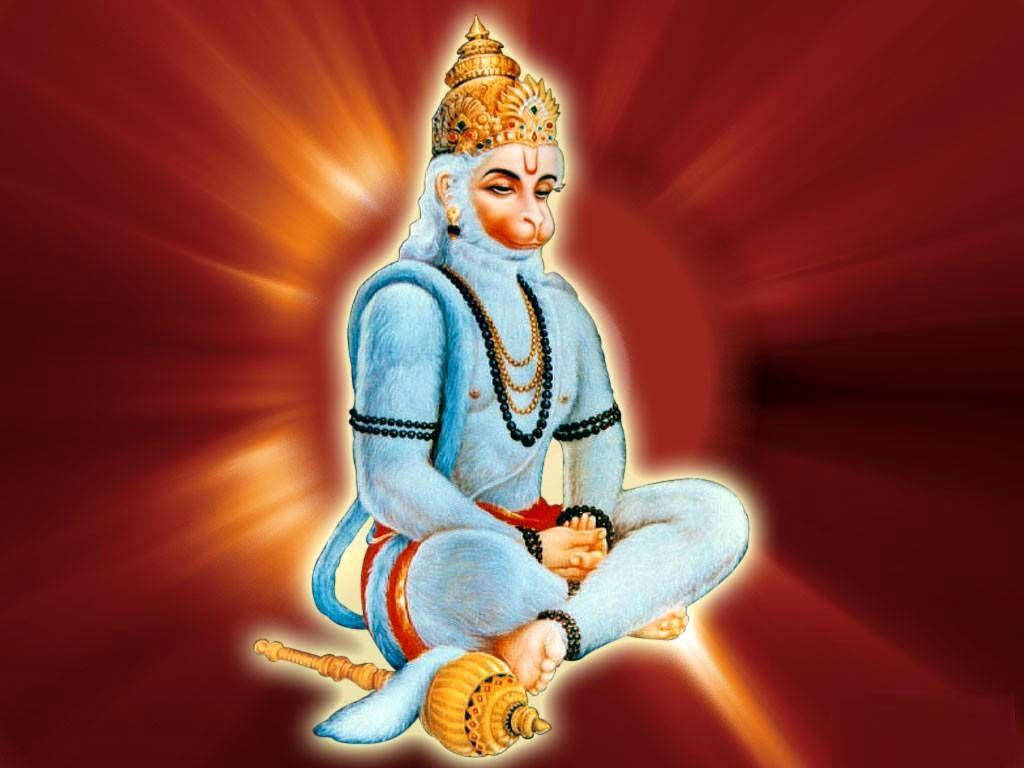 hanuman art 桌布 壁紙 — 一位寧靜的藍皮膚猴神，頭戴金色皇冠，盤腿而坐，在發光的紅色背景前散發光芒。
