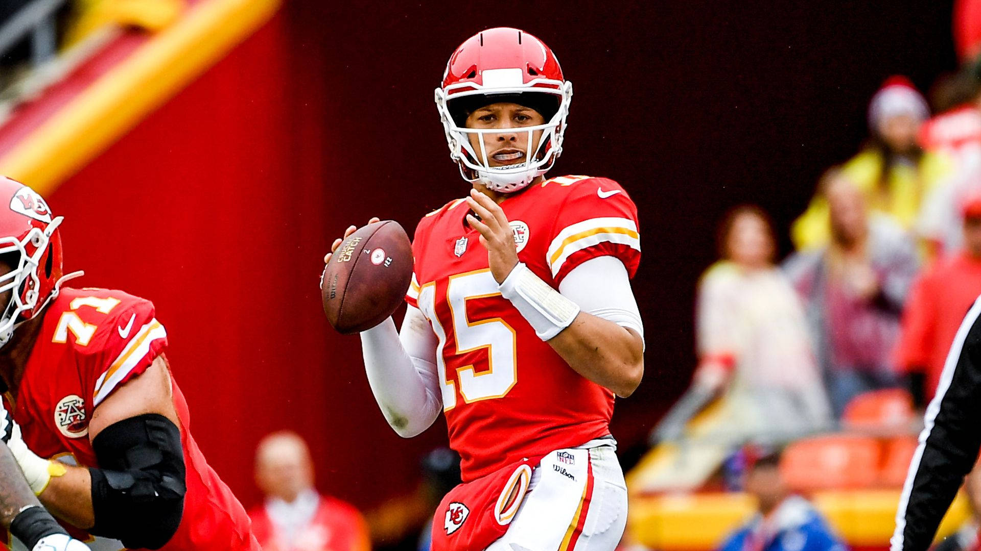 身穿紅色制服的NFL四分衛在比賽中準備投擲橄欖球。 — 派翠克·馬霍姆斯 GIF 壁紙