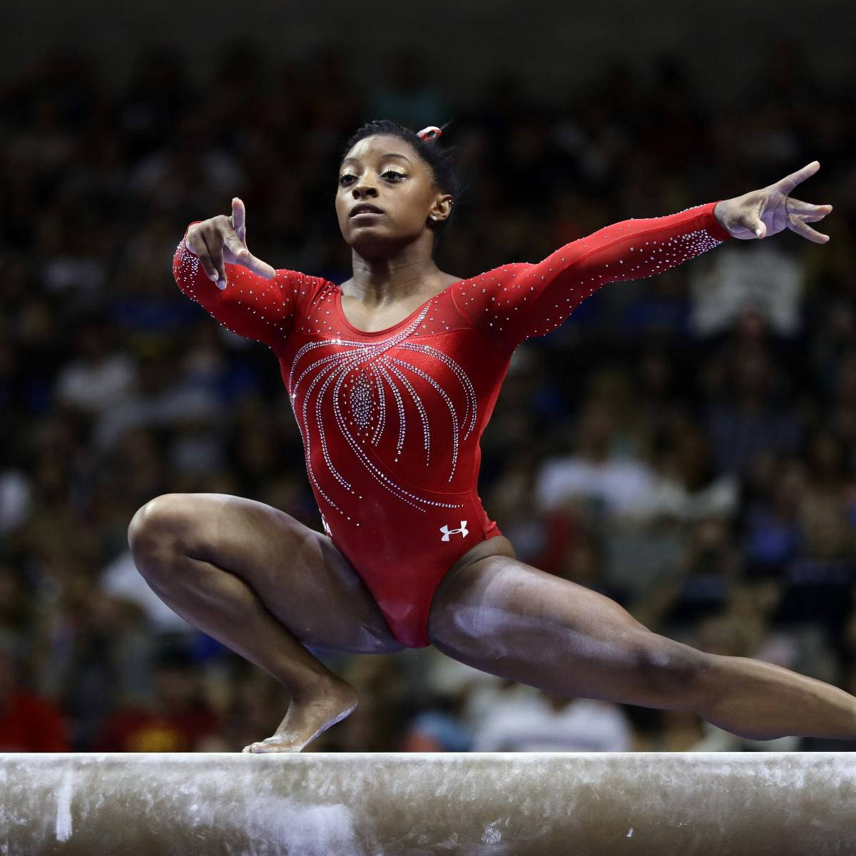 Olympics 桌布 壁紙 — 一位專注的體操運動員穿著紅色閃亮緊身衣，在平衡木上做出優雅的姿勢。
