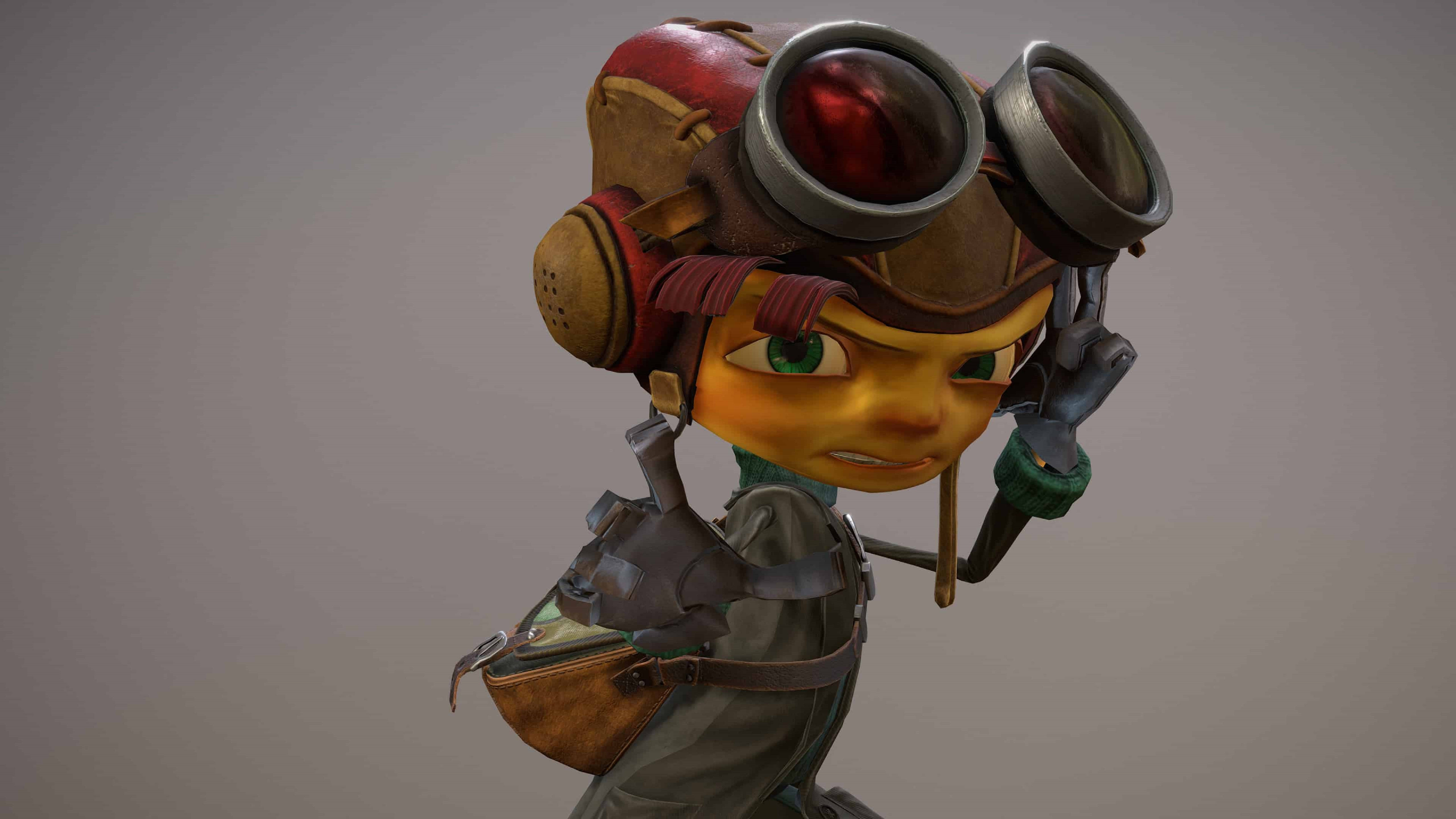 Psychonauts 桌布 壁紙 — 一位戴著護目鏡和皮革裝備的蒸氣龐克冒險家，在純灰色背景下專注地凝視。