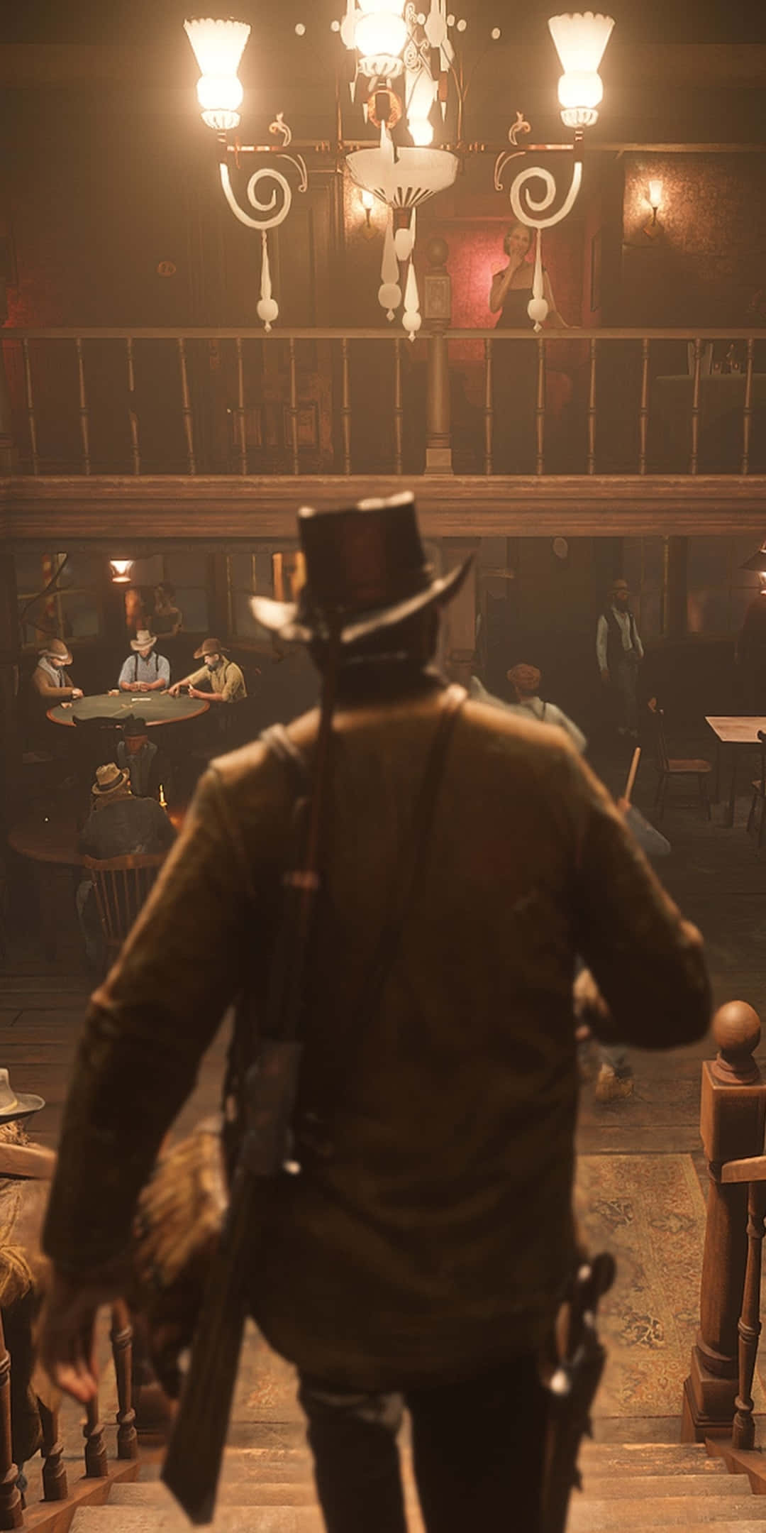 Red Dead Redemtion 2 桌布 壁紙 — 一位戴高帽、持步槍的牛仔走下樓梯，進入一個燈光昏暗的沙龍，顧客坐在桌旁，頭頂有吊燈。