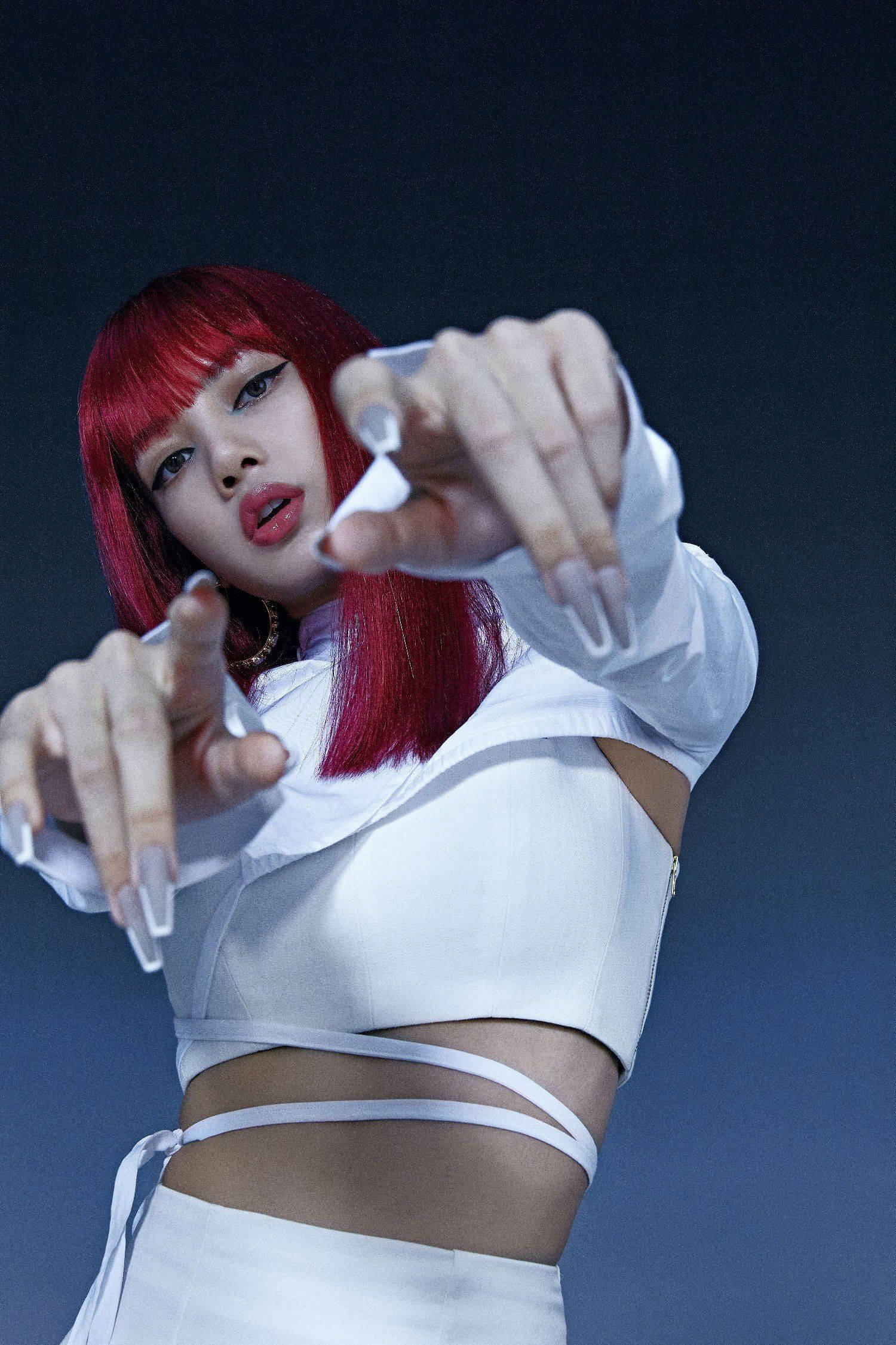 Lalisa 桌布 壁紙 — 一位擁有鮮豔紅髮和白色服裝的女性，在深藍色背景下向觀眾伸出手指。