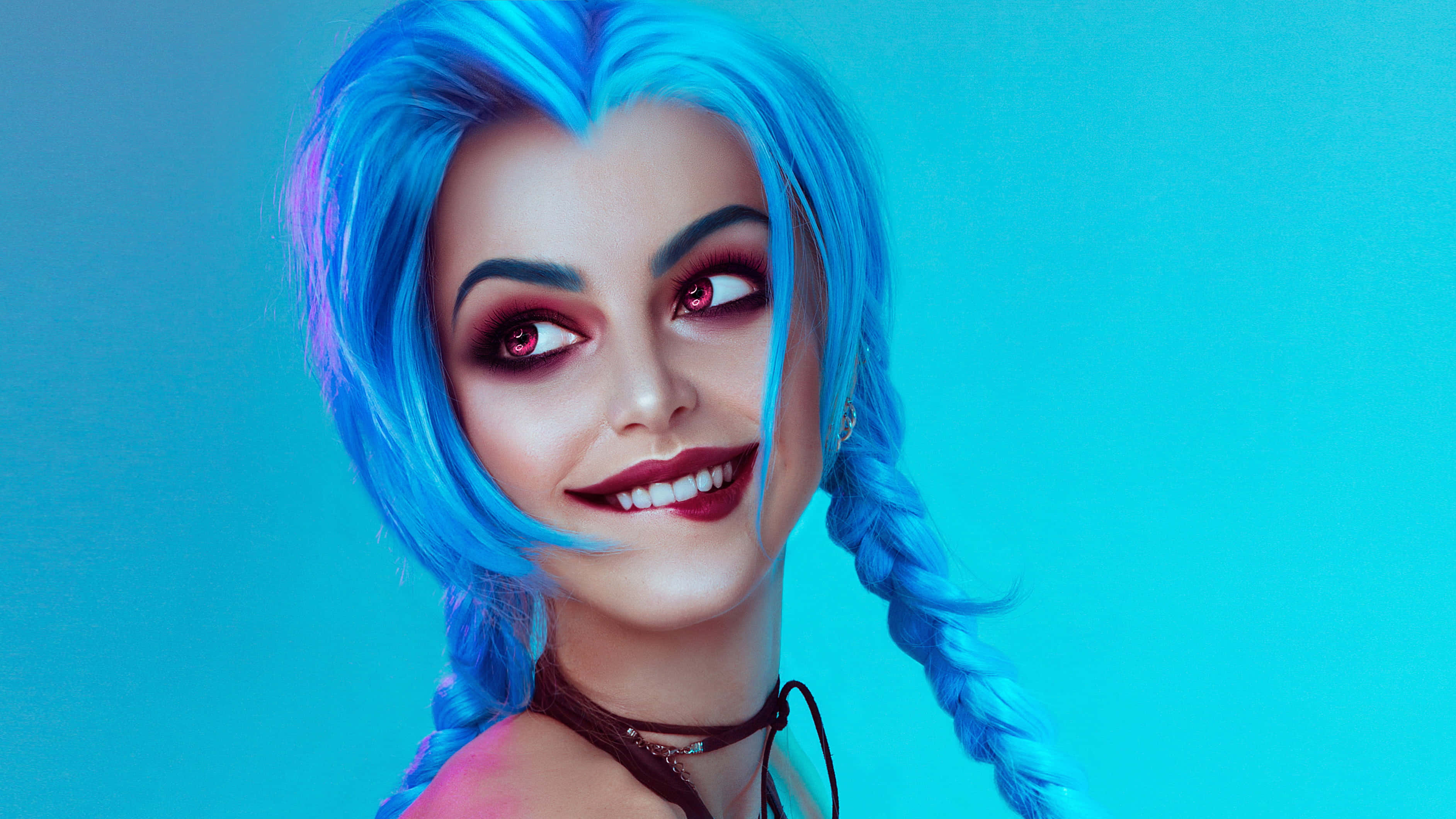 Gaming Cosplay 桌布 壁紙 — 一位擁有鮮豔藍色辮子頭髮和引人注目的紅眼睛的女性在純青色背景上微笑。