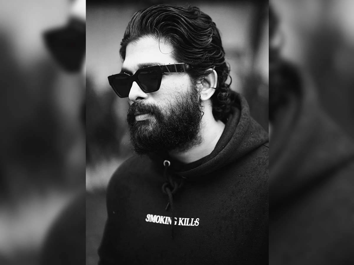 Allu Arjun 桌布 壁紙 — 一位時尚的鬍鬚男戴著太陽眼鏡和連帽衫，在充滿氛圍的黑白肖像中凝視著鏡頭外。