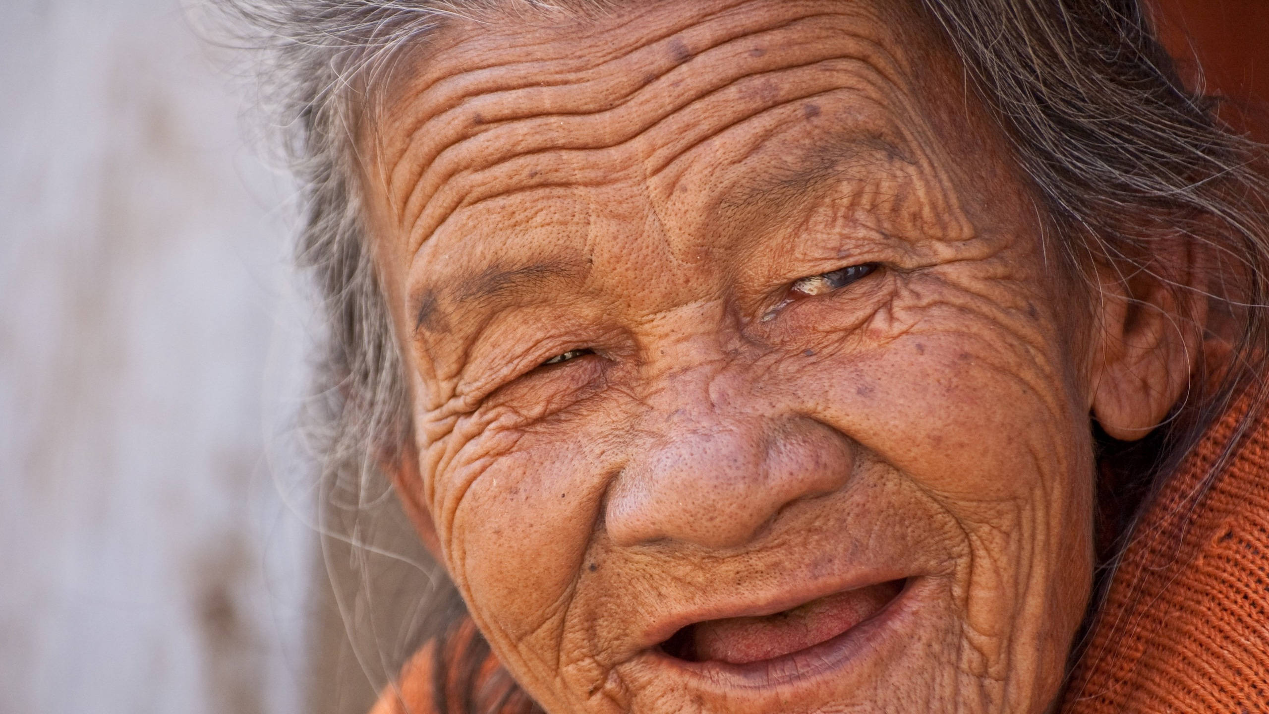 Woman 桌布 壁紙 — 一位皮膚深陷皺紋、灰白頭髮的老婦人在柔和自然光線中溫暖微笑的特寫。