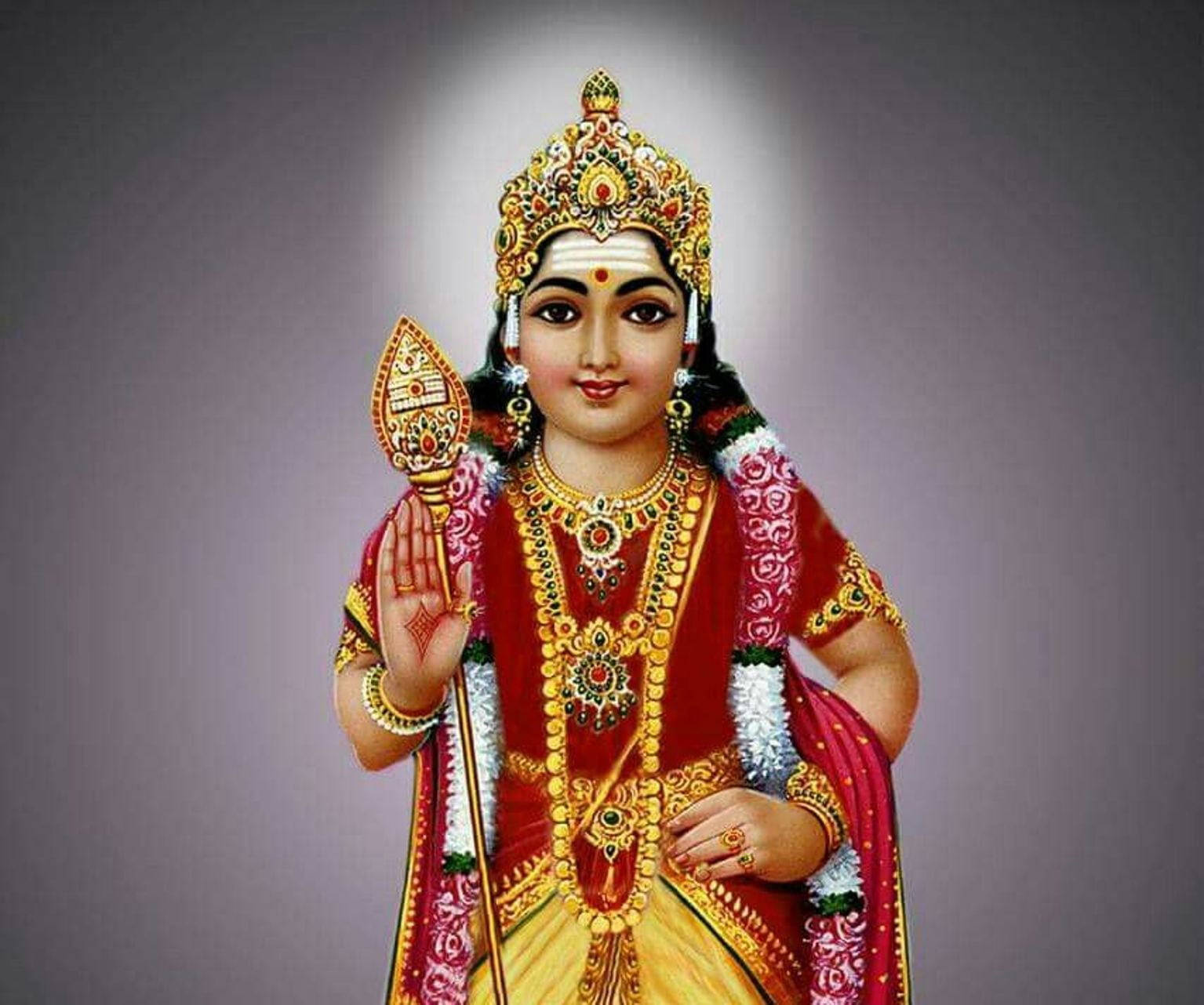 Tamil God 桌布 壁紙 — 一位神聖的印度教女神，身穿耀眼的紅色和金色服飾，佩戴精緻珠寶，頭後有光環。