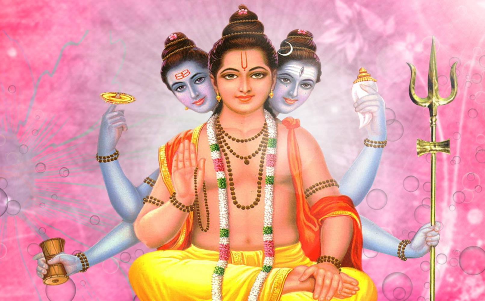 Hindu God 桌布 壁紙 — 一位神聖的印度教神祇，擁有四臂三面，佩戴花環和珠寶，寧靜地坐在粉紅色泡泡背景前。