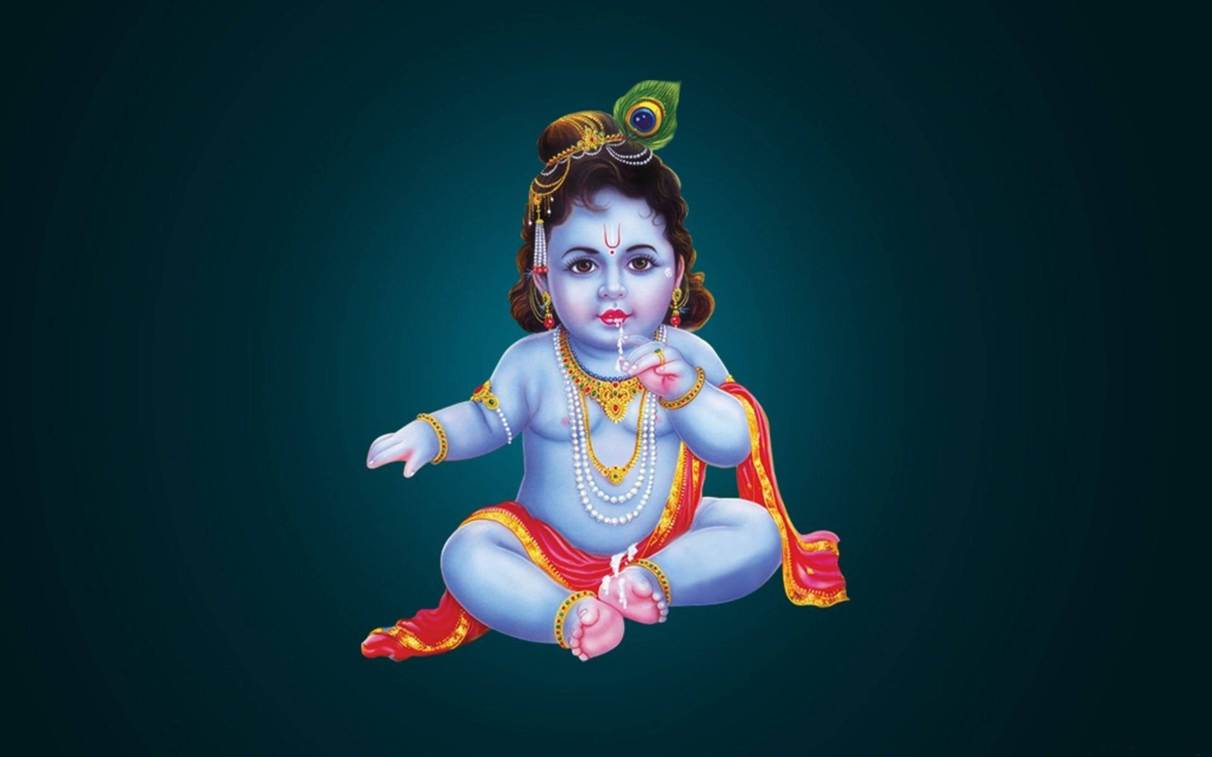 Indian 桌布 壁紙 — 一位神聖的藍皮膚嬰兒神祇，飾有珠寶和孔雀羽毛，在深藍綠色漸變背景上盤腿而坐。